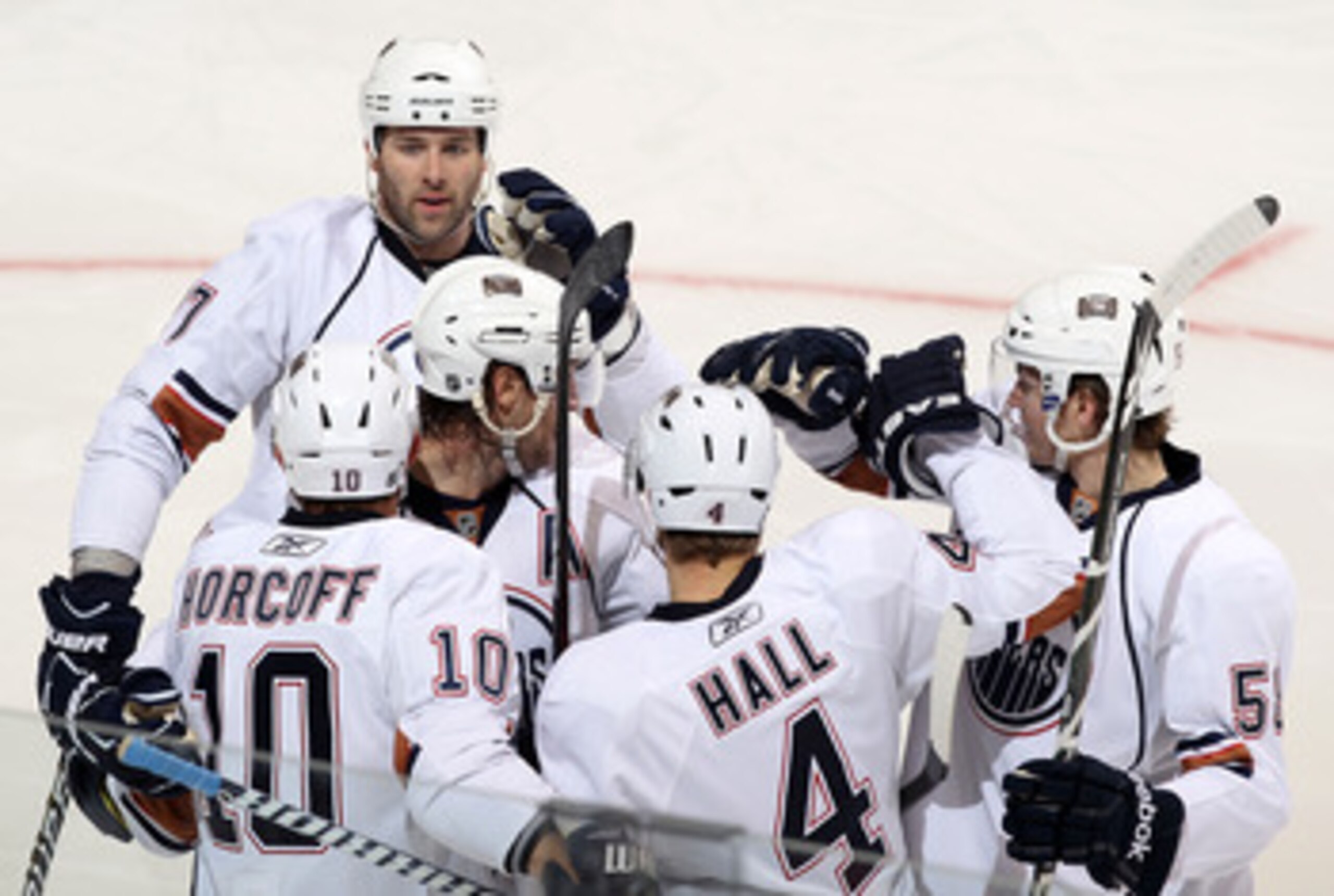 GLENDALE, AZ - JANUARY 25:  (L-R) Dustin Penner #27, Shawn Horcoff #10, Tom Gilbert #77, Taylor Hall #4 and Jeff Petry #58 of the Edmonton Oilers celebrate after Hall scored a third period power play goal against the Phoenix Coyotes during the NHL game at