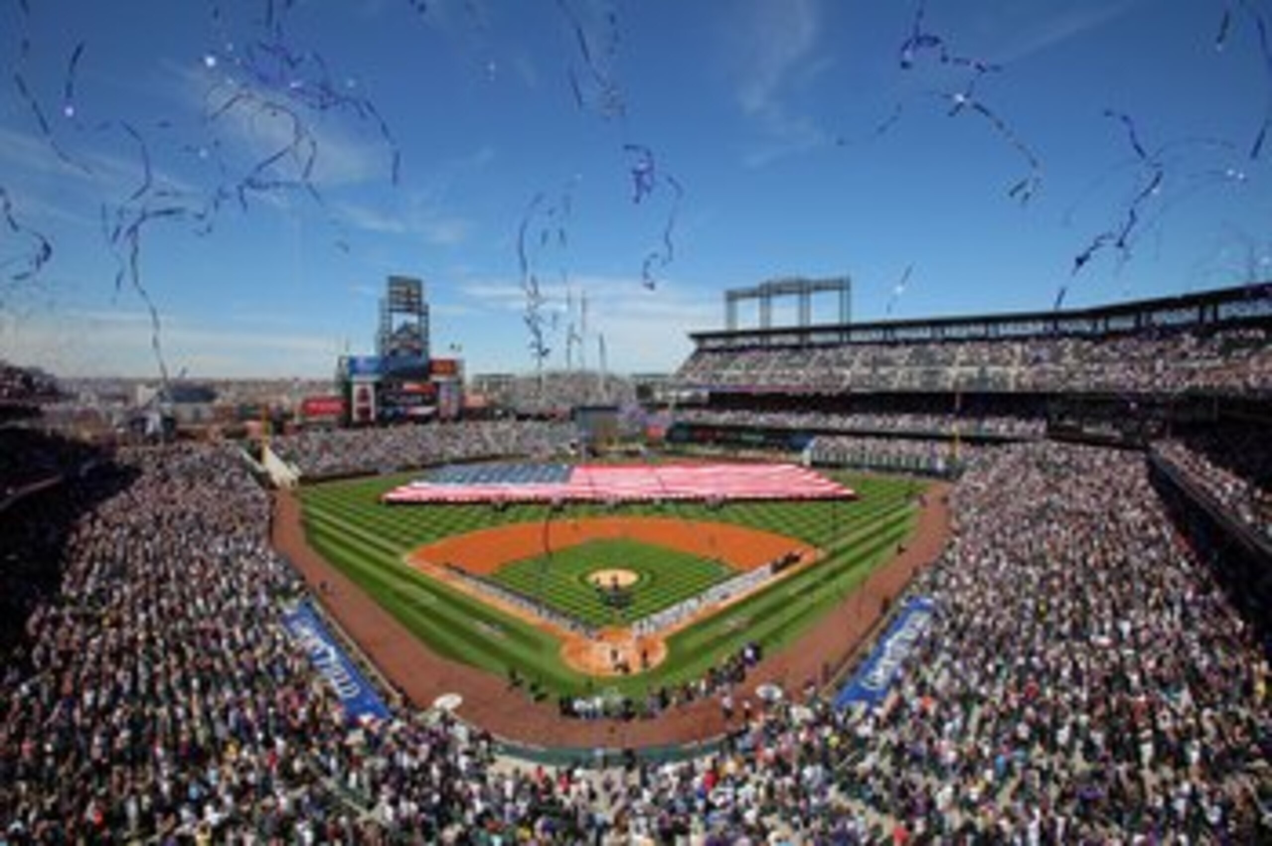 DENVER - APRIL 09:  Players and fans observe the national anthem as the stars and stripes is presented by members of the US military as the Colorado Rockies host the San Diego Padres during MLB action on Opening Day at Coors Field on April 9, 2010 in Denv