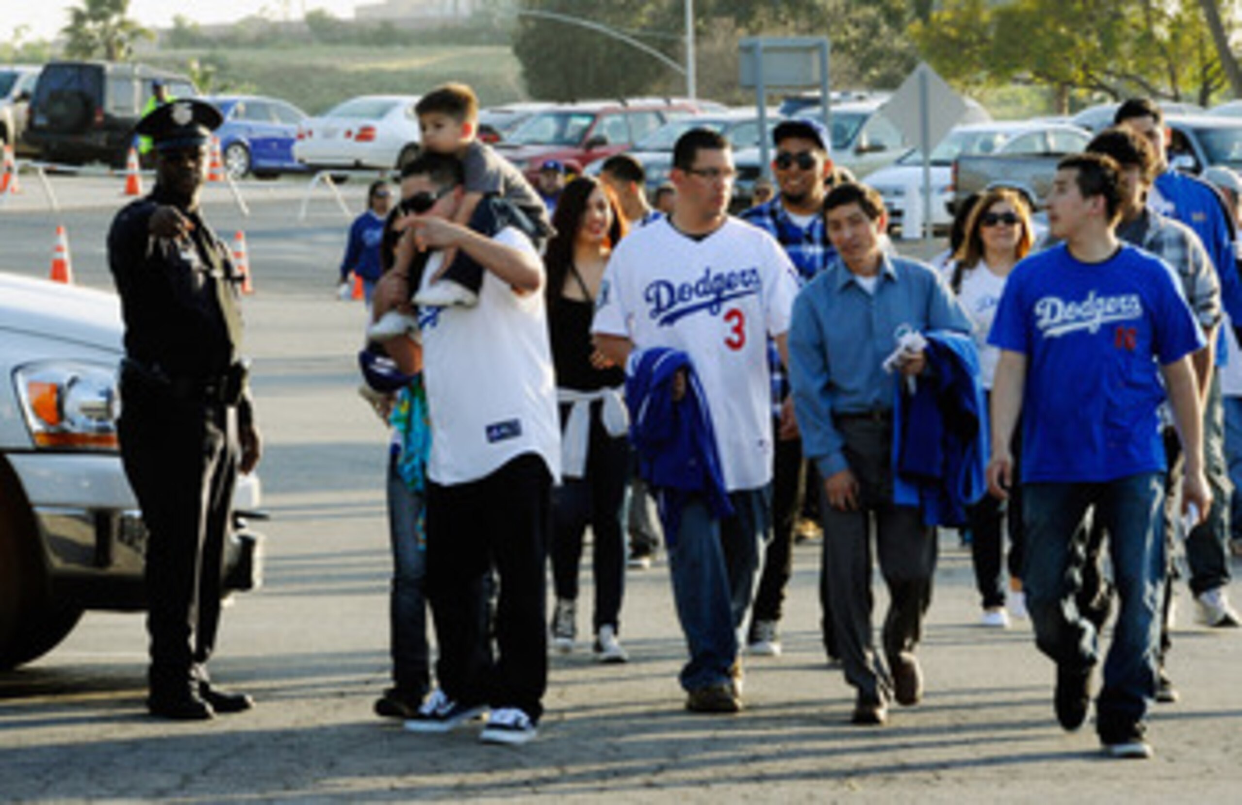 LOS ANGELES, CA - APRIL 14:  Los Angels Dodger fans ask for direction from a Los Angeles Police Department officer at Dodger Stadium prior to the start of the St. Louis Cardinals and Los Angeles Dodgers baseball game on April 14, 2011 in Los Angeles, Cali