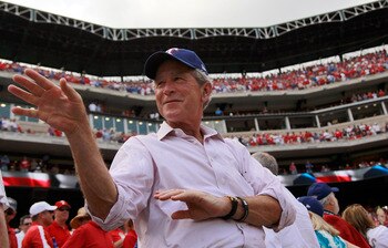 ARLINGTON, TX - APRIL 01:  Former U.S. President George W. Bush waves to a fan on Opening Day at Rangers Ballpark in Arlington on April 1, 2011 in Arlington, Texas.  (Photo by Tom Pennington/Getty Images)