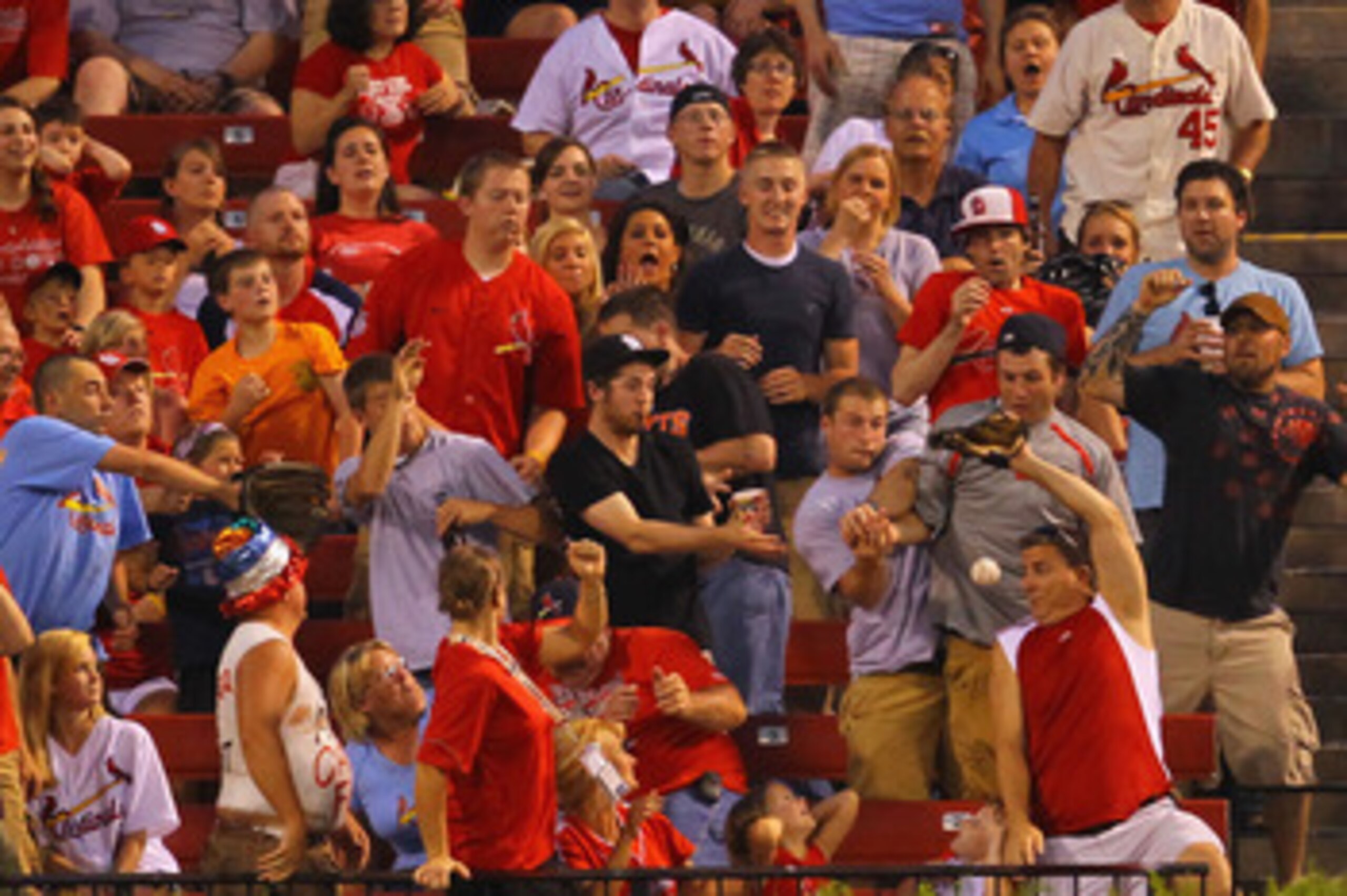 ST. LOUIS, MO - JUNE 2: Fans clamor to catch a a home run ball hit by Aubrey Huff #17 of the San Francisco Giants against the St. Louis Cardinals at Busch Stadium on June 2, 2011 in St. Louis, Missouri.  (Photo by Dilip Vishwanat/Getty Images)