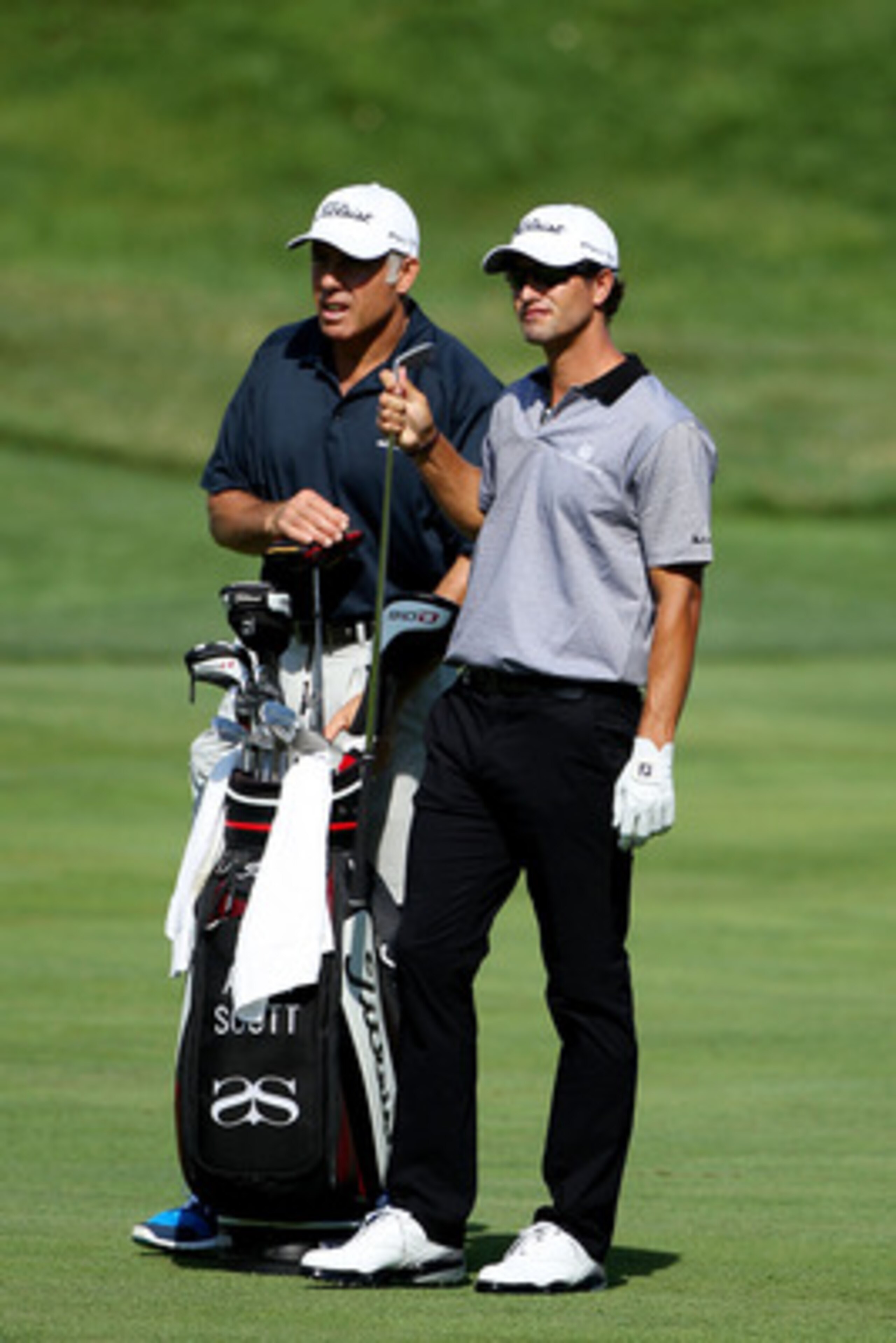 BETHESDA, MD - JUNE 13:  Adam Scott of Australia (R) pulls a club from his bag as his caddie Steve Williams (L) looks on during a practice round prior to the start of the 111th U.S. Open at Congressional Country Club on June 13, 2011 in Bethesda, Maryland