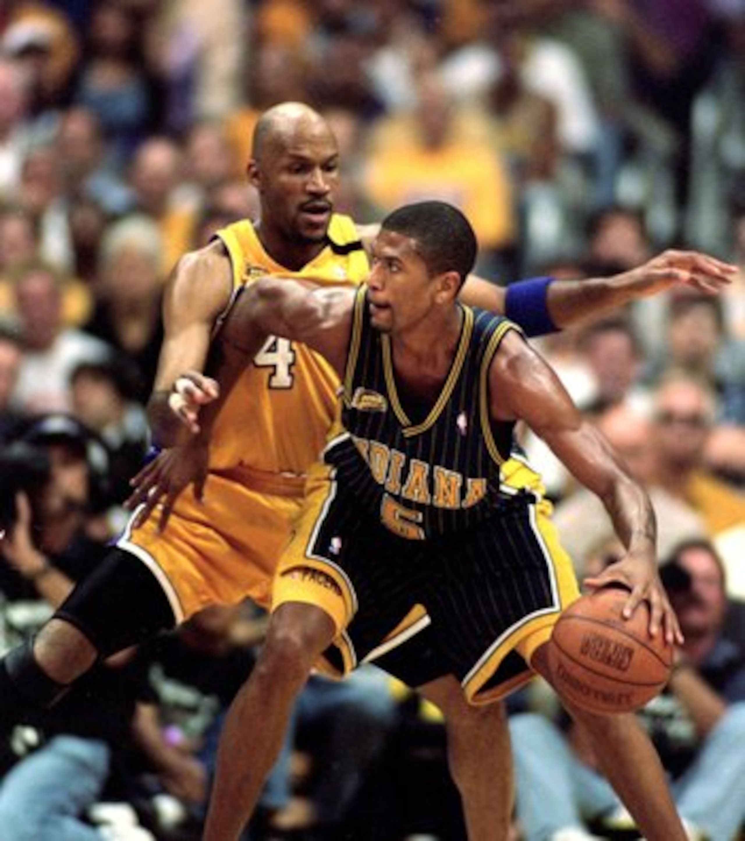 19 Jun 2000:  Jalen Rose #5 of the Indiana Pacers moves with the ball as Ron Harper #4 of the Los Angeles Lakers gaurds him during the NBA Finals Game 6 at the Staples Center in Los Angeles, California.  The Lakers defeated the Pacers in 116-111.  NOTE TO
