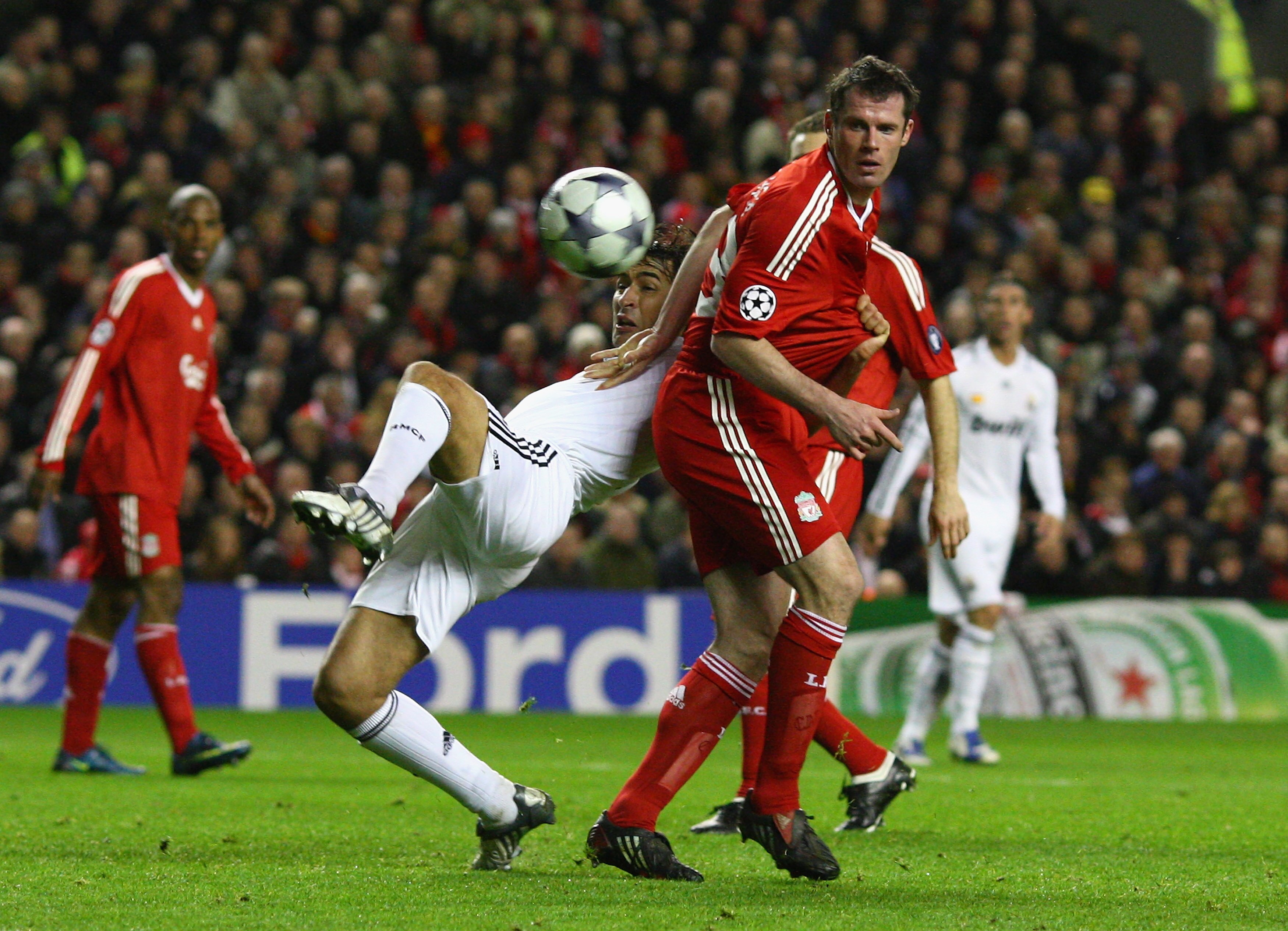 LIVERPOOL, UNITED KINGDOM - MARCH 10:  Jamie Carragher of Liverpool tangles with Raul of Real Madrid during the UEFA Champions League Round of Sixteen, Second Leg match between Liverpool and Real Madrid at Anfield on March 10, 2009 in Liverpool, England.
