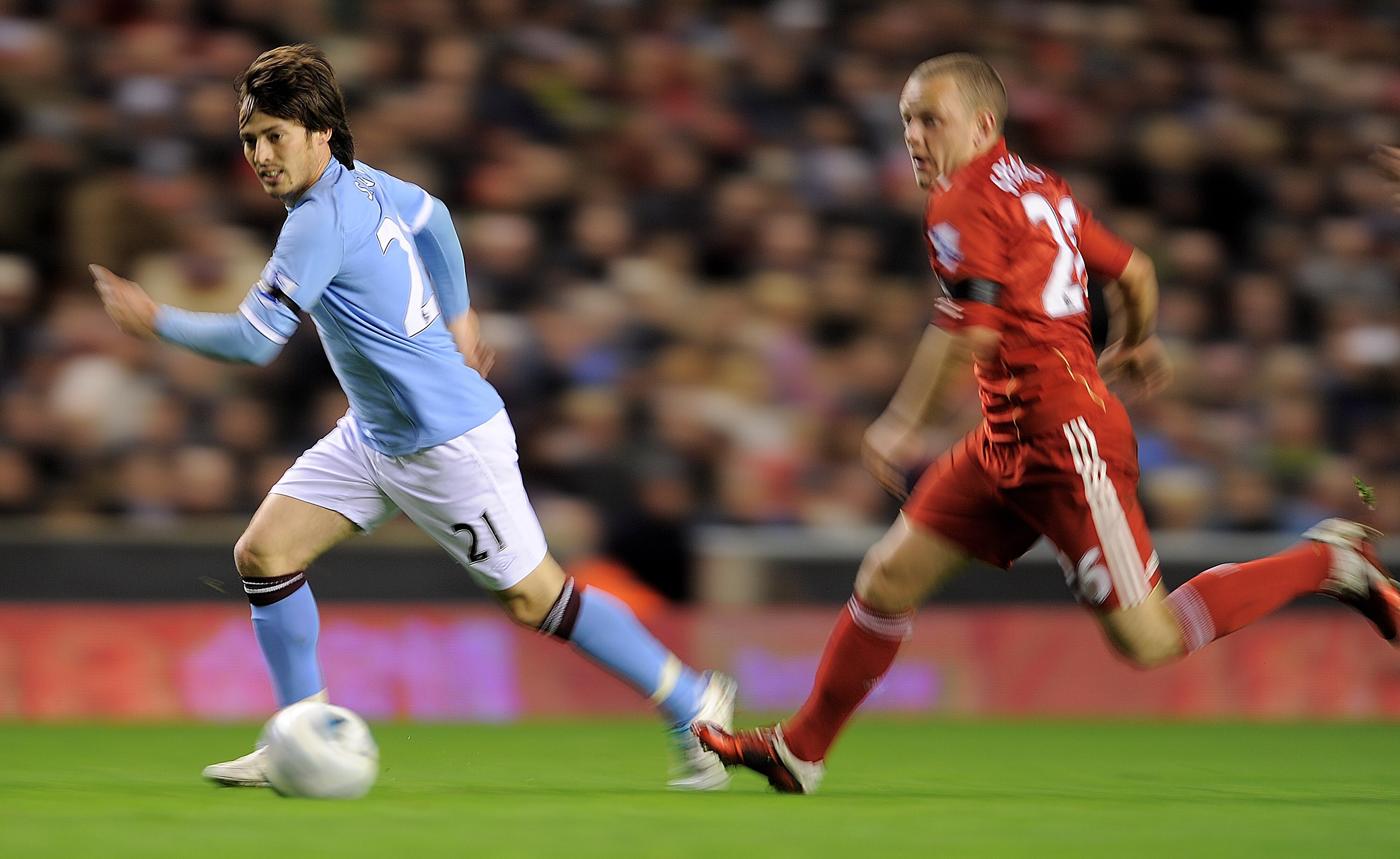 LIVERPOOL, ENGLAND - APRIL 11:   David Silva of Manchester City is pursued by Jay Spearing of Liverpool during the Barclays Premier League match between Liverpool and Manchester City at Anfield on April 11, 2011 in Liverpool, England. (Photo by Michael Re