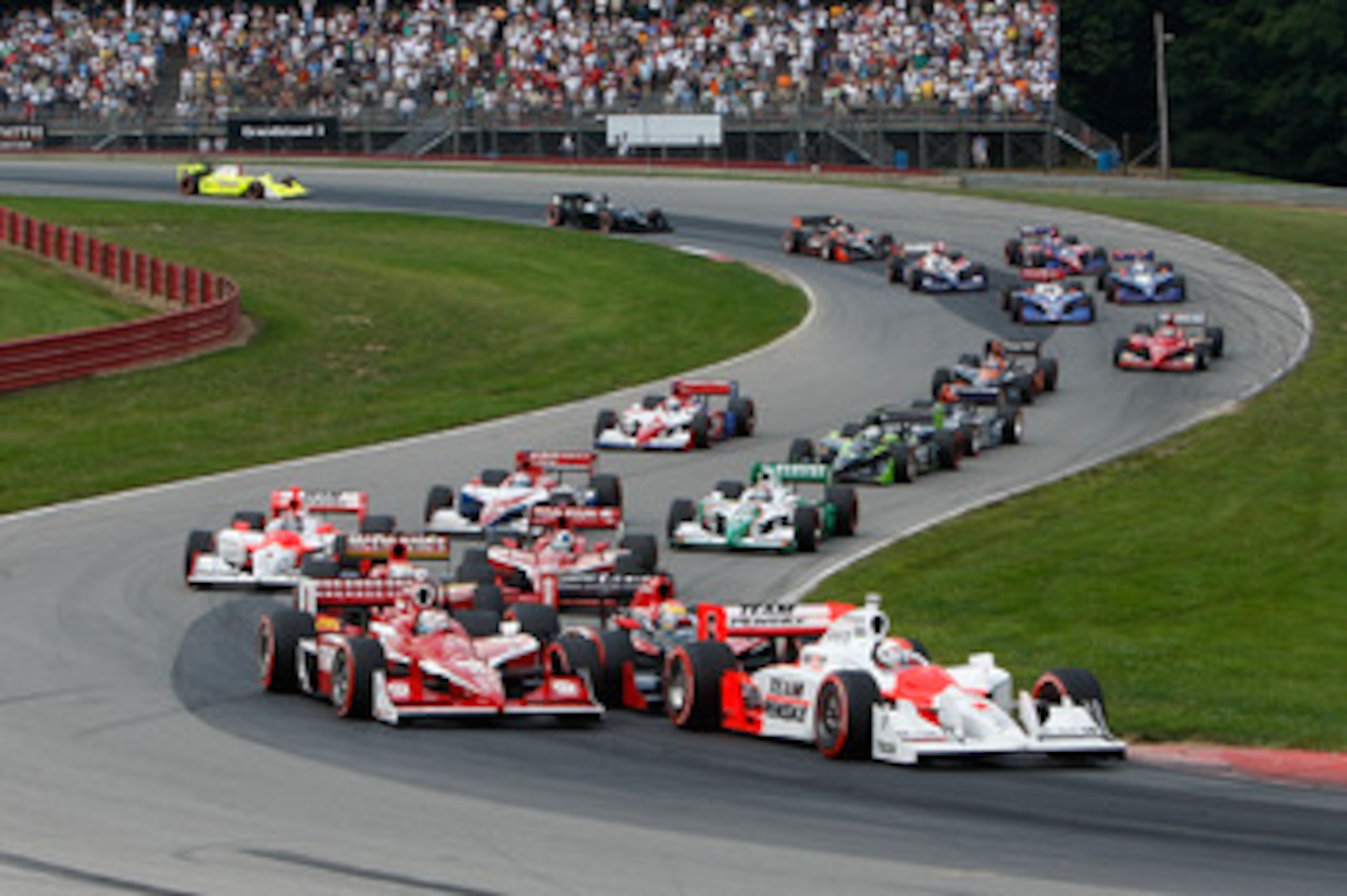 LEXINGTON, OH - AUGUST 09:  Ryan Briscoe, driver of the #6 Team Penske Dallara Honda, leads the field at the start of the IRL IndyCar Series The Honda Indy 200 at the Mid-Ohio Sports Car Course on August 9, 2009 in Lexington, Ohio.  (Photo by Streeter Lec