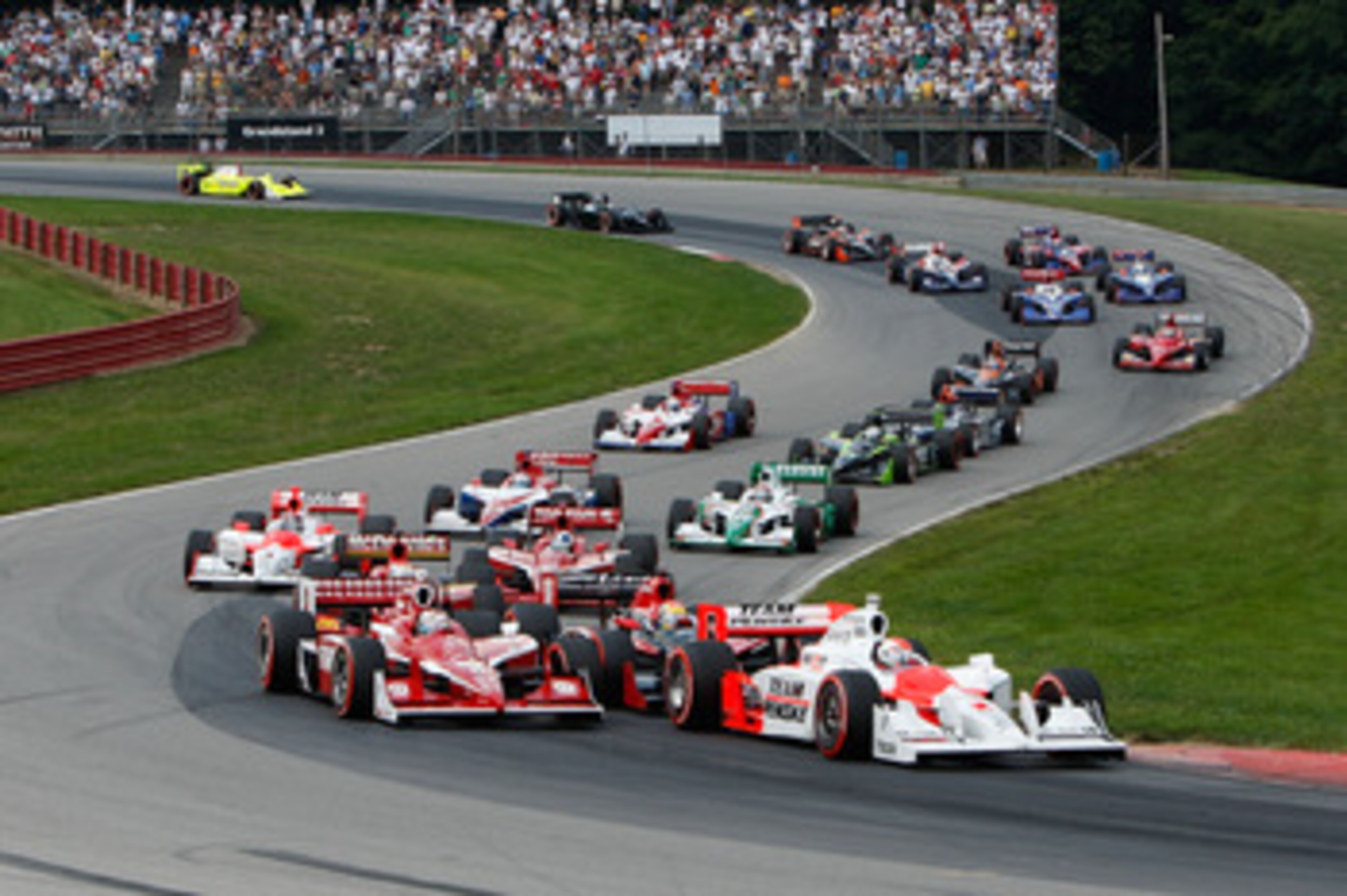 LEXINGTON, OH - AUGUST 09:  Ryan Briscoe, driver of the #6 Team Penske Dallara Honda, leads the field at the start of the IRL IndyCar Series The Honda Indy 200 at the Mid-Ohio Sports Car Course on August 9, 2009 in Lexington, Ohio.  (Photo by Streeter Lec