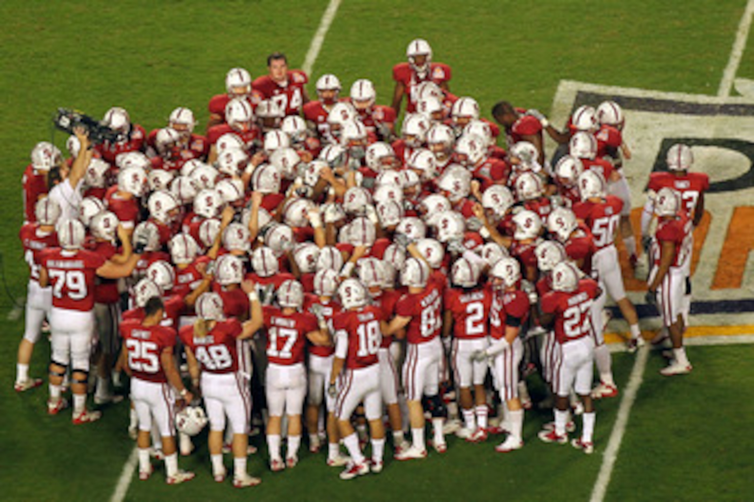 MIAMI, FL - JANUARY 03:  The Stanford Cardinal huddle on the field prior to playing against the Virginia Tech Hokies during the 2011 Discover Orange Bowl at Sun Life Stadium on January 3, 2011 in Miami, Florida. Stanford won 40-12. (Photo by Mike Ehrmann/
