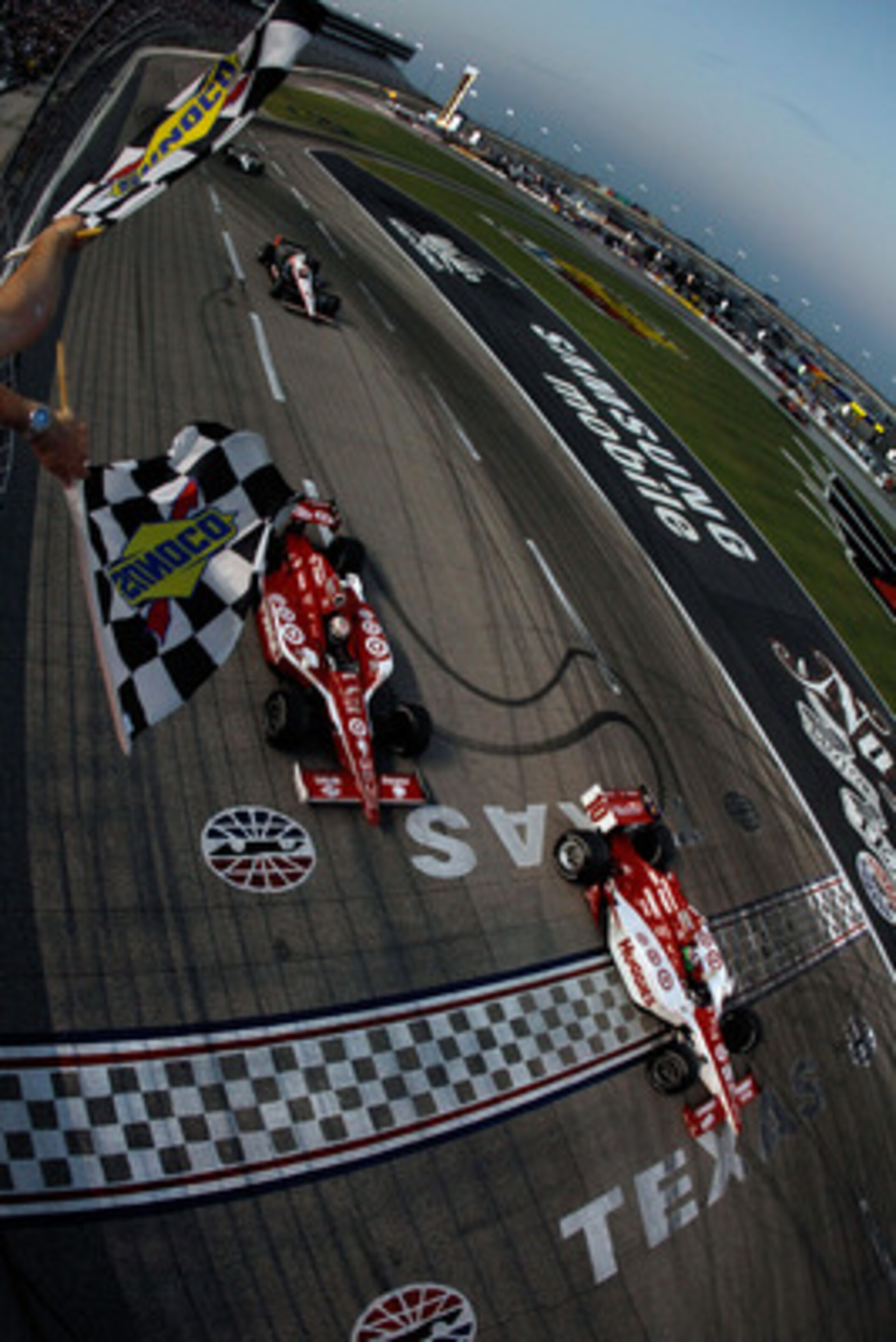 FORT WORTH, TX - JUNE 11:  Dario Franchitti of Scotland, driver of the #10 Target Chip Ganassi Racing Dallara Honda, crosses the finish line ahead of teammate Scott Dixon of New Zealand, driver of the #9 Target Chip Ganassi Racing Dallara Honda, to win ra