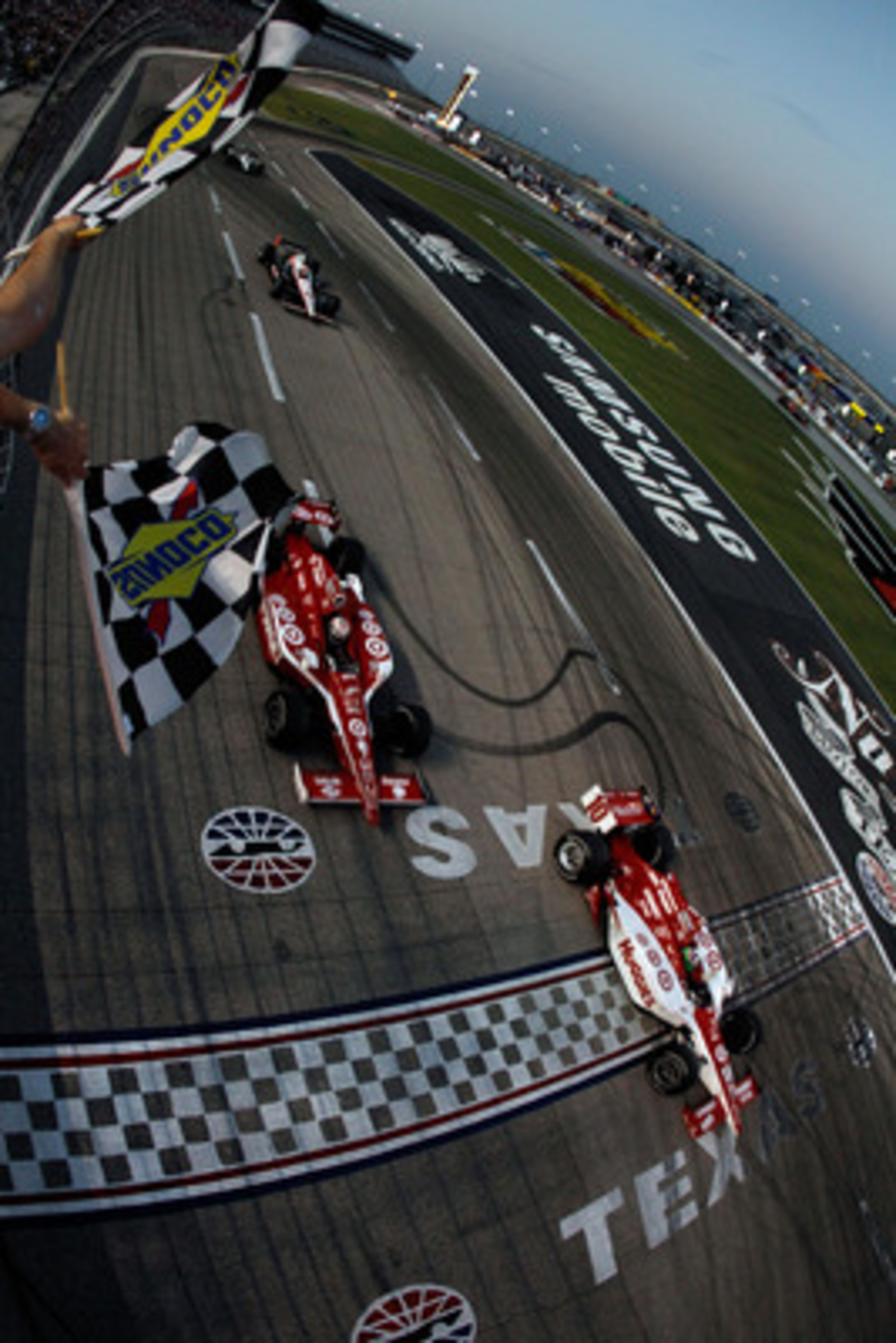 FORT WORTH, TX - JUNE 11:  Dario Franchitti of Scotland, driver of the #10 Target Chip Ganassi Racing Dallara Honda, crosses the finish line ahead of teammate Scott Dixon of New Zealand, driver of the #9 Target Chip Ganassi Racing Dallara Honda, to win ra