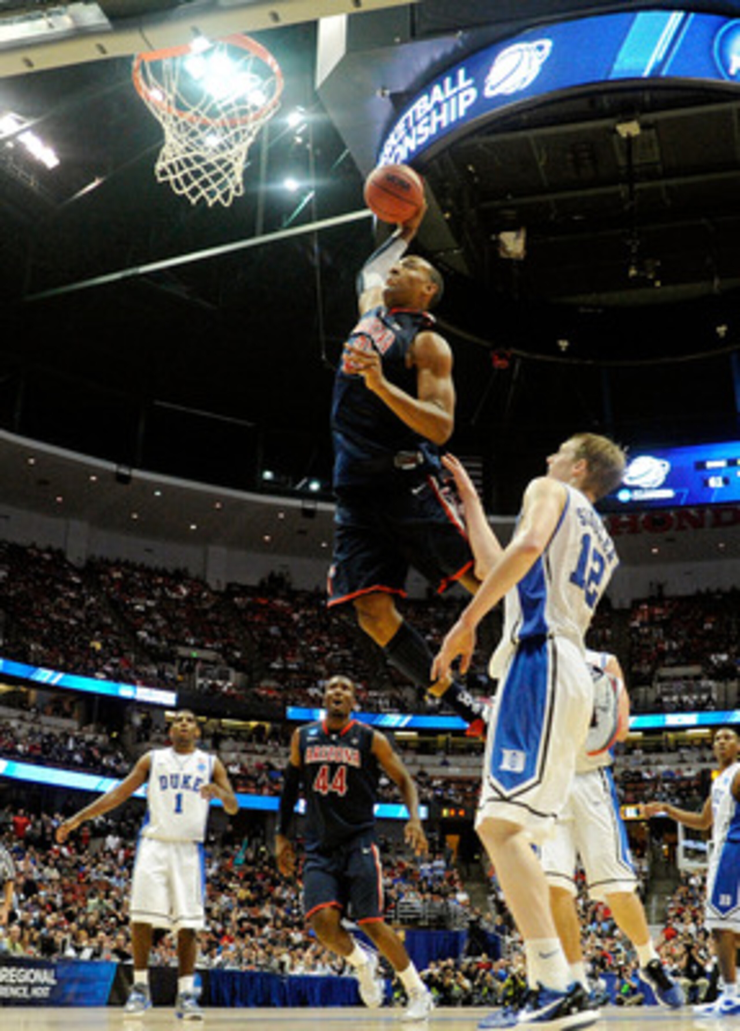 ANAHEIM, CA - MARCH 24:  Derrick Williams #23 of the Arizona Wildcats dunks the over Kyle Singler #12 of the Duke Blue Devils during the west regional semifinal of the 2011 NCAA men's basketball tournament at the Honda Center on March 24, 2011 in Anaheim,