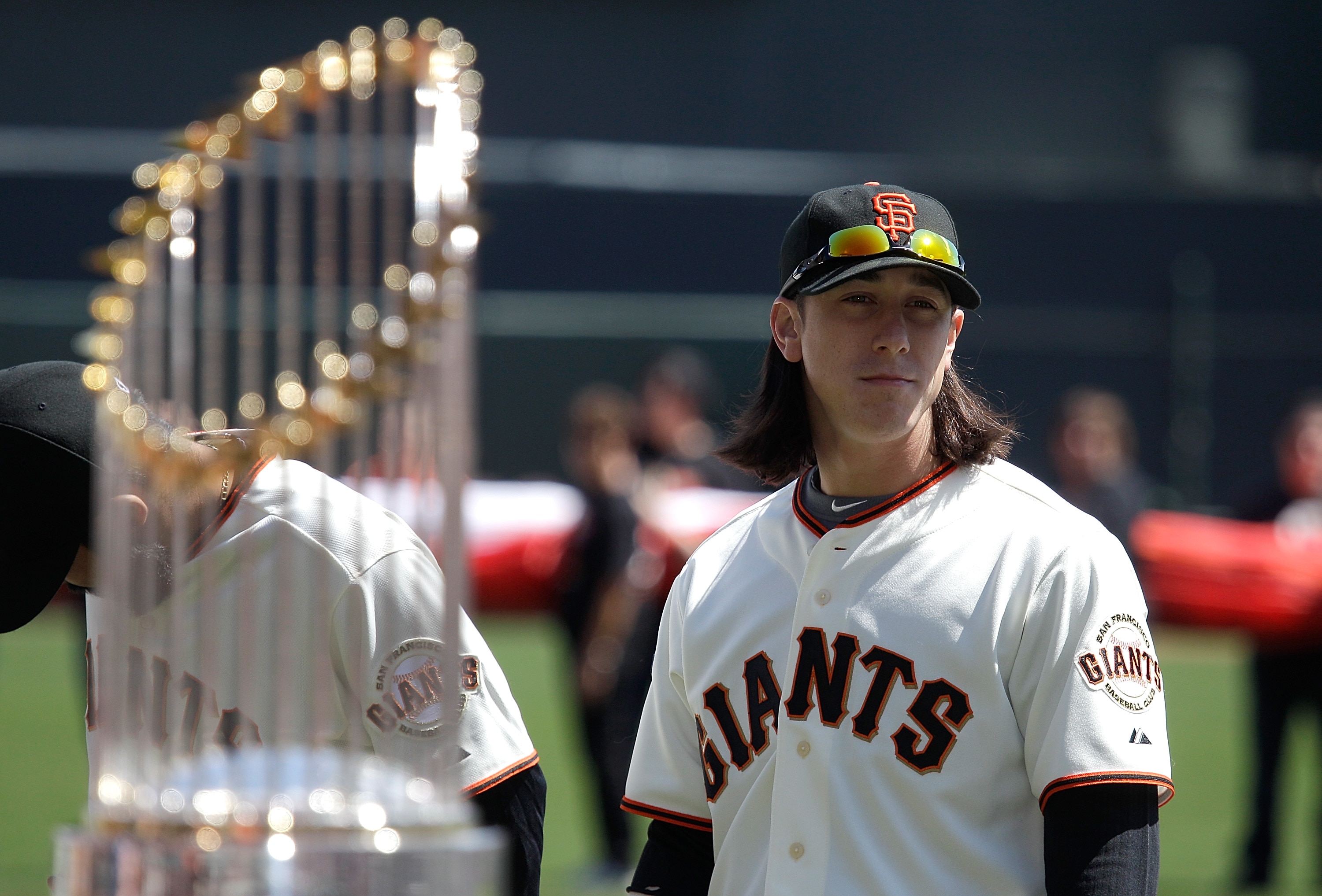 SAN FRANCISCO, CA - APRIL 08:  Tim Lincecum #55 of the San Francisco looks on as he stands next to the 2010 World Series trophy before the start of the Giants' opening day game against the St. Louis Cardinals at AT&T Park on April 8, 2011 in San Francisco