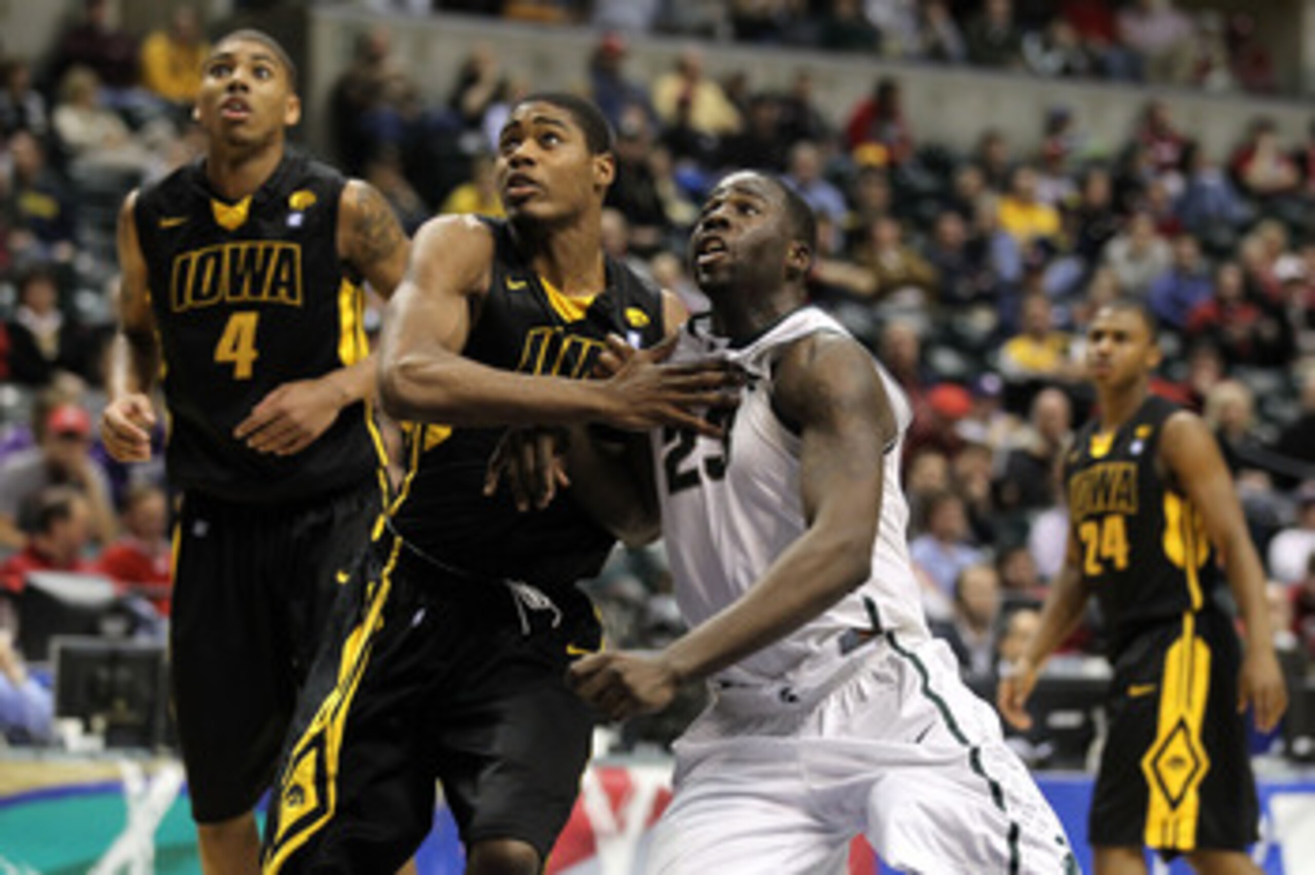 INDIANAPOLIS, IN - MARCH 10:  Draymond Green #23 of the Michigan State Spartans fights for rebound position against Melsahn Basabe #1 of the Iowa Hawkeyes during the first round of the 2011 Big Ten Men's Basketball Tournament at Conseco Fieldhouse on Marc