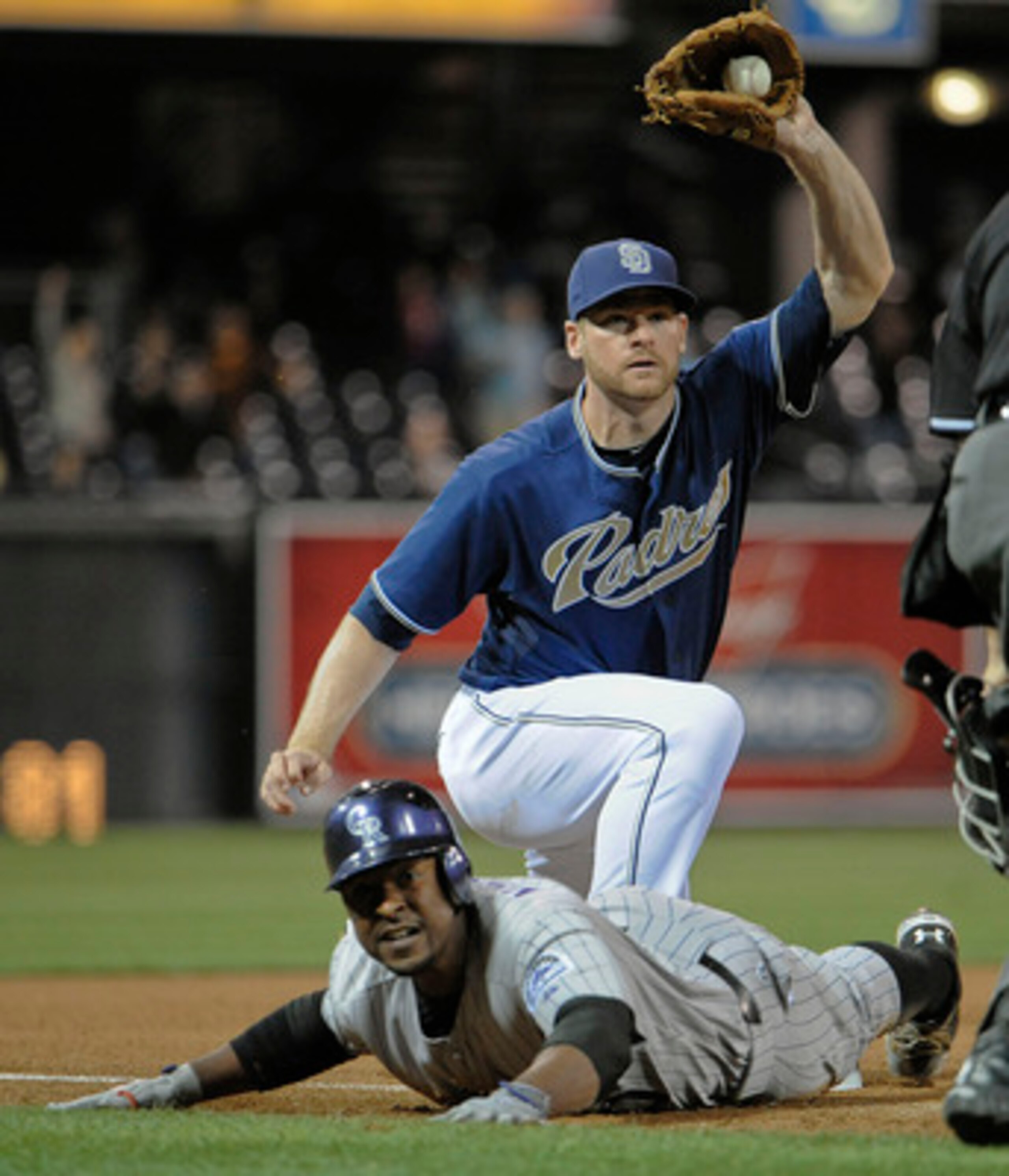 SAN DIEGO, CA - JUNE 6: Chris Nelson #10 of the Colorado Rockies is tagged out at third base by Chase Headley #7 of the San Diego Padres during the sixth inning of a baseball game at Petco Park on June 6, 2011 in San Diego, California. Nelson tried to str SAN DIEGO, CA - JUNE 6: Chris Nelson #10 of the Colorado Rockies is tagged out at third base by Chase Headley #7 of the San Diego Padres during the sixth inning of a baseball game at Petco Park on June 6, 2011 in San Diego, California. Nelson tried to str