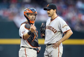 PHOENIX, AZ - APRIL 16:  Catcher Buster Posey #28 of the San Francisco Giants signals for a trainer after starting pitcher Barry Zito #75 was injured during the Major League Baseball game against the Arizona Diamondbacks at Chase Field on April 16, 2011 i