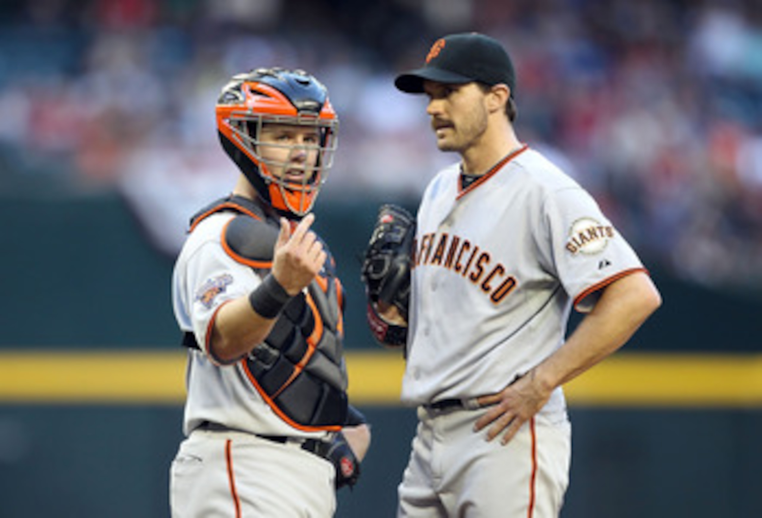 PHOENIX, AZ - APRIL 16:  Catcher Buster Posey #28 of the San Francisco Giants signals for a trainer after starting pitcher Barry Zito #75 was injured during the Major League Baseball game against the Arizona Diamondbacks at Chase Field on April 16, 2011 i