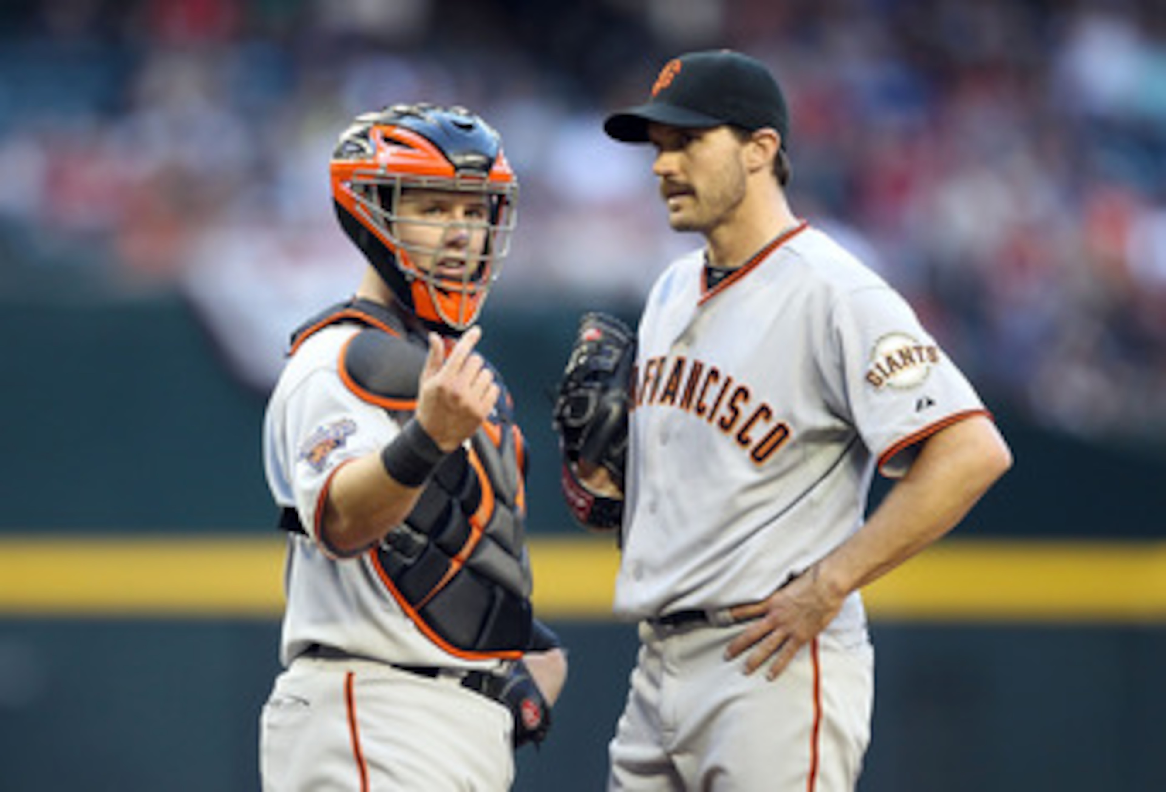 PHOENIX, AZ - APRIL 16:  Catcher Buster Posey #28 of the San Francisco Giants signals for a trainer after starting pitcher Barry Zito #75 was injured during the Major League Baseball game against the Arizona Diamondbacks at Chase Field on April 16, 2011 i