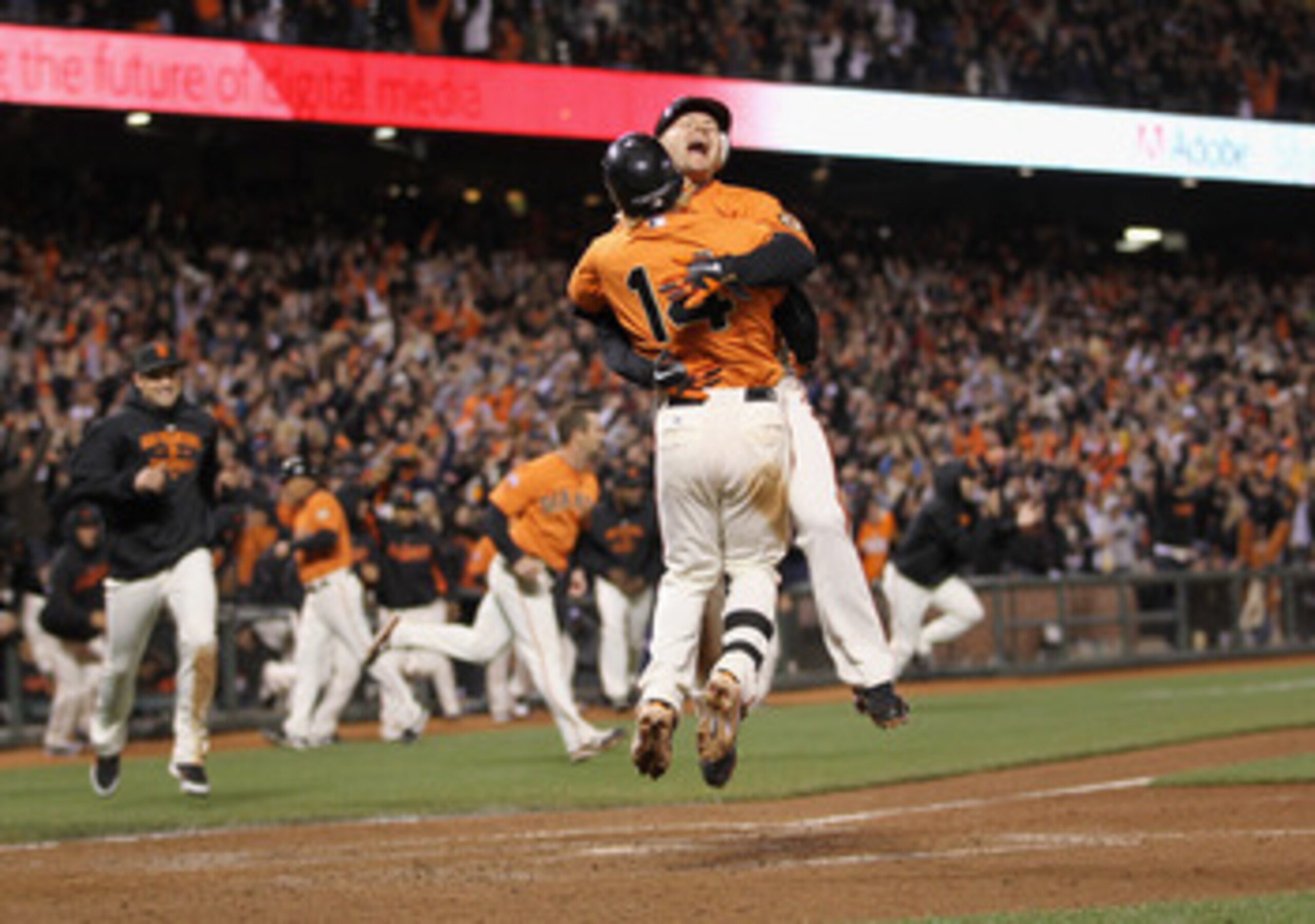 SAN FRANCISCO, CA - MAY 06:  Cody Ross #13 and Mike Fontenot #14 of the San Francisco Giants celebrate after Ross scored the winning run on a hit by Freddy Sanchez #21 in the bottom of the ninth inning against the Colorado Rockies at AT&T Park on May 6, 2