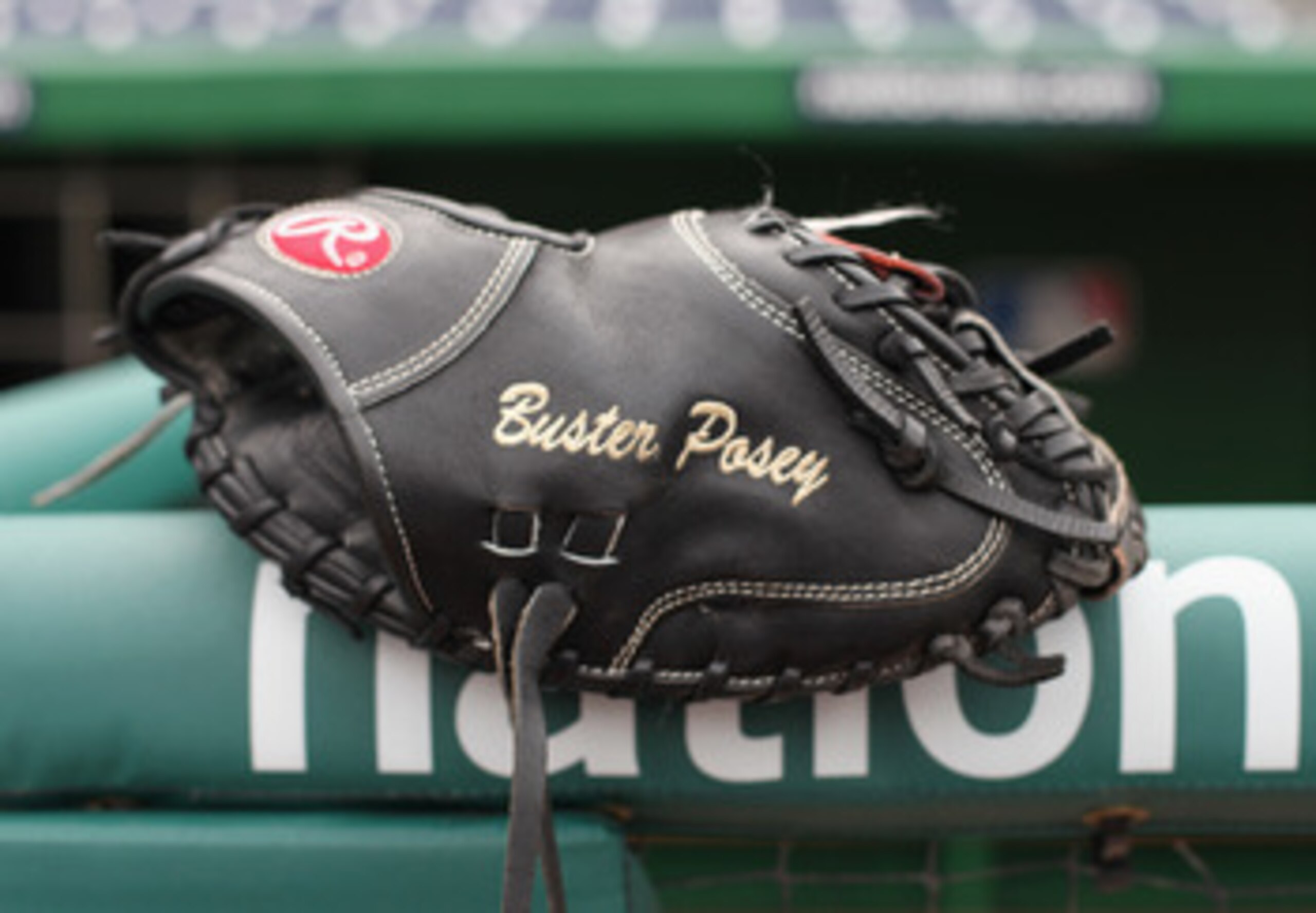 WASHINGTON, DC - APRIL 29:  The glove of catcher Buster Posey #28 of the San Francisco Giants rests on the railing in the dugout before the start of the Gaints game against the Washington Nationals at Nationals Park on April 29, 2011 in Washington, DC.  (