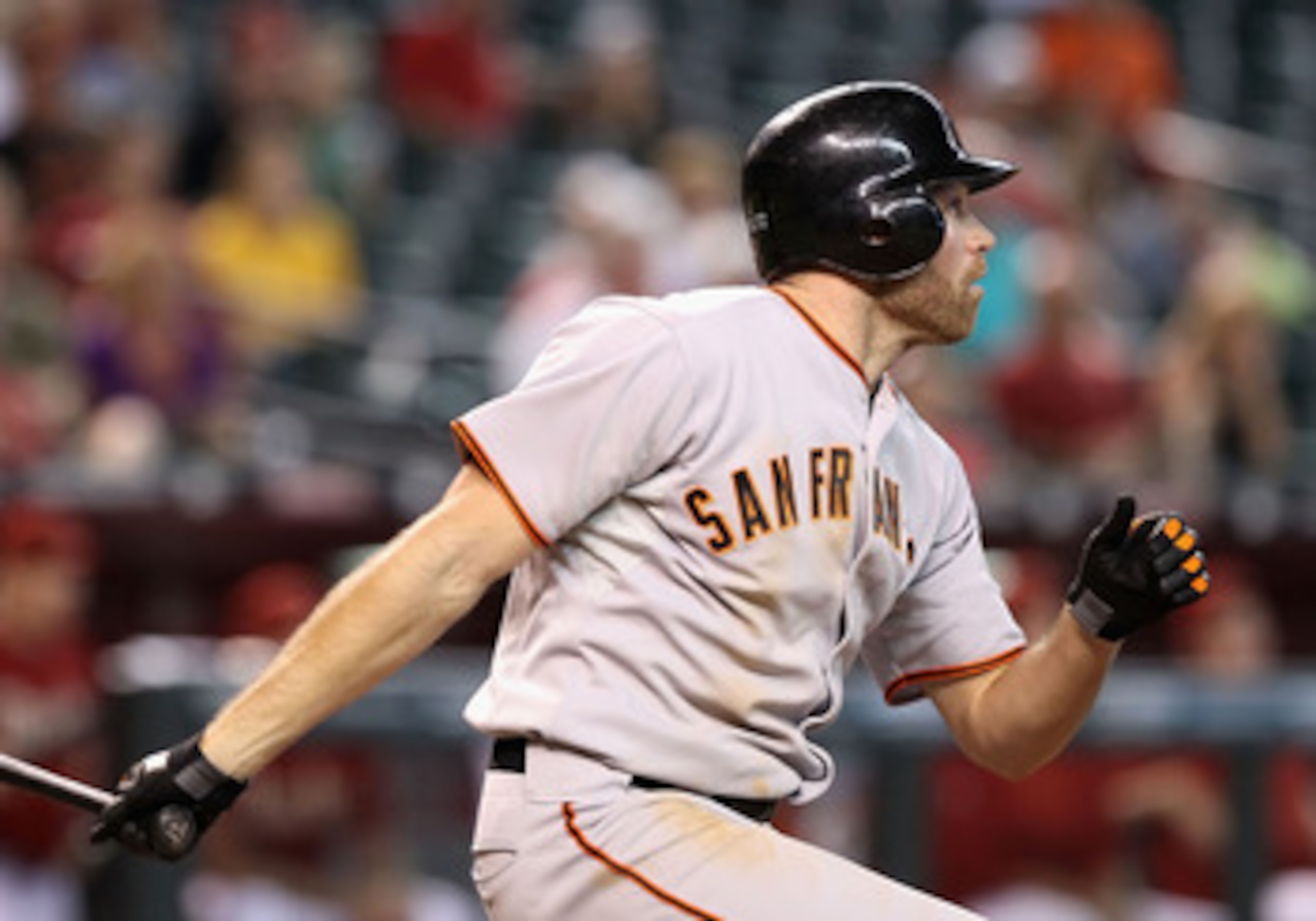 PHOENIX - SEPTEMBER 06:  Nate Schierholtz #12 of the San Francisco Giants hits a 2 RBI triple against the Arizona Diamondbacks during the eleventh inning of the Major League Baseball game at Chase Field on September 6, 2010 in Phoenix, Arizona.  (Photo by