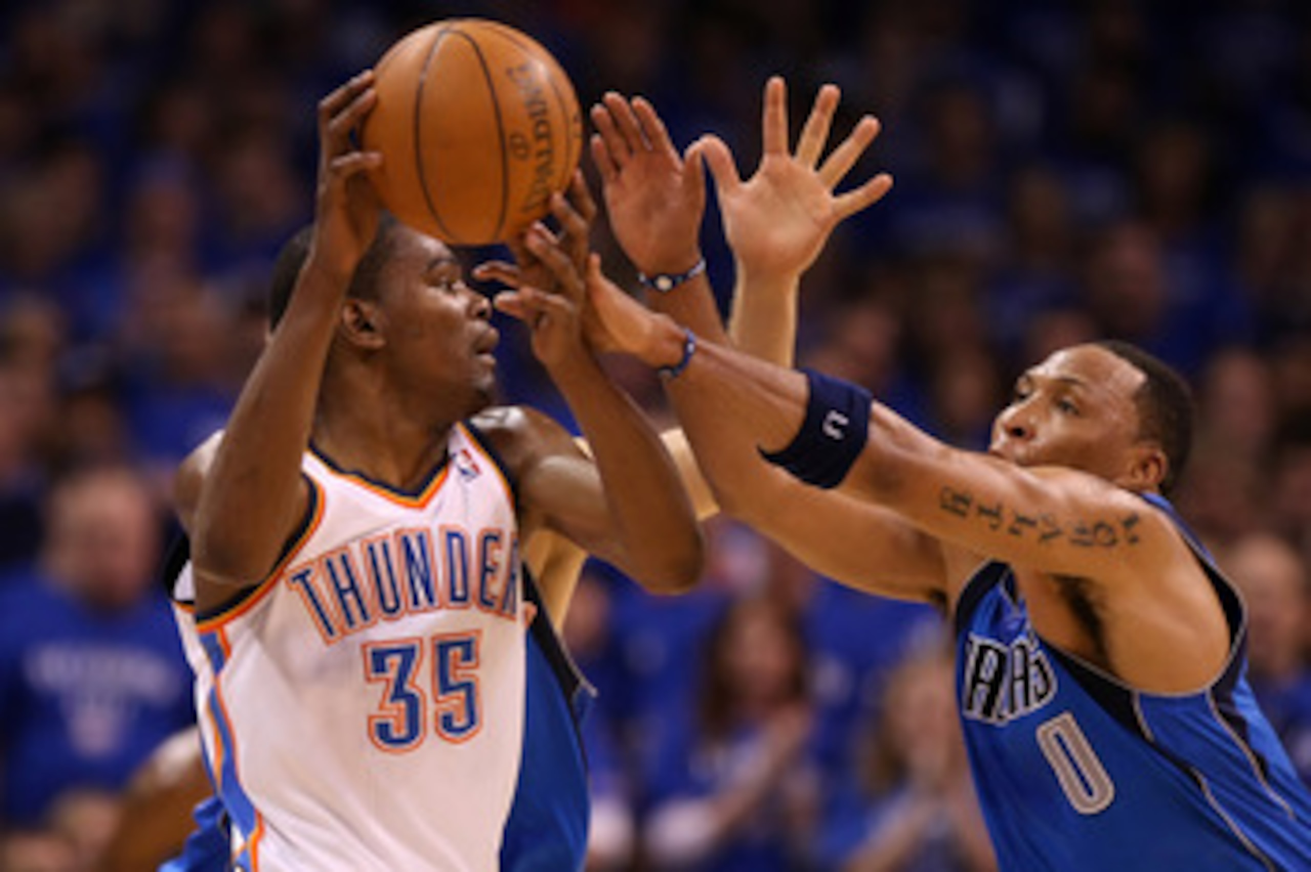 OKLAHOMA CITY, OK - MAY 23:  Kevin Durant #35 of the Oklahoma City Thunder moves the ball as Shawn Marion #0 of the Dallas Mavericks goes after the ball in the first half in Game Four of the Western Conference Finals during the 2011 NBA Playoffs at Oklaho
