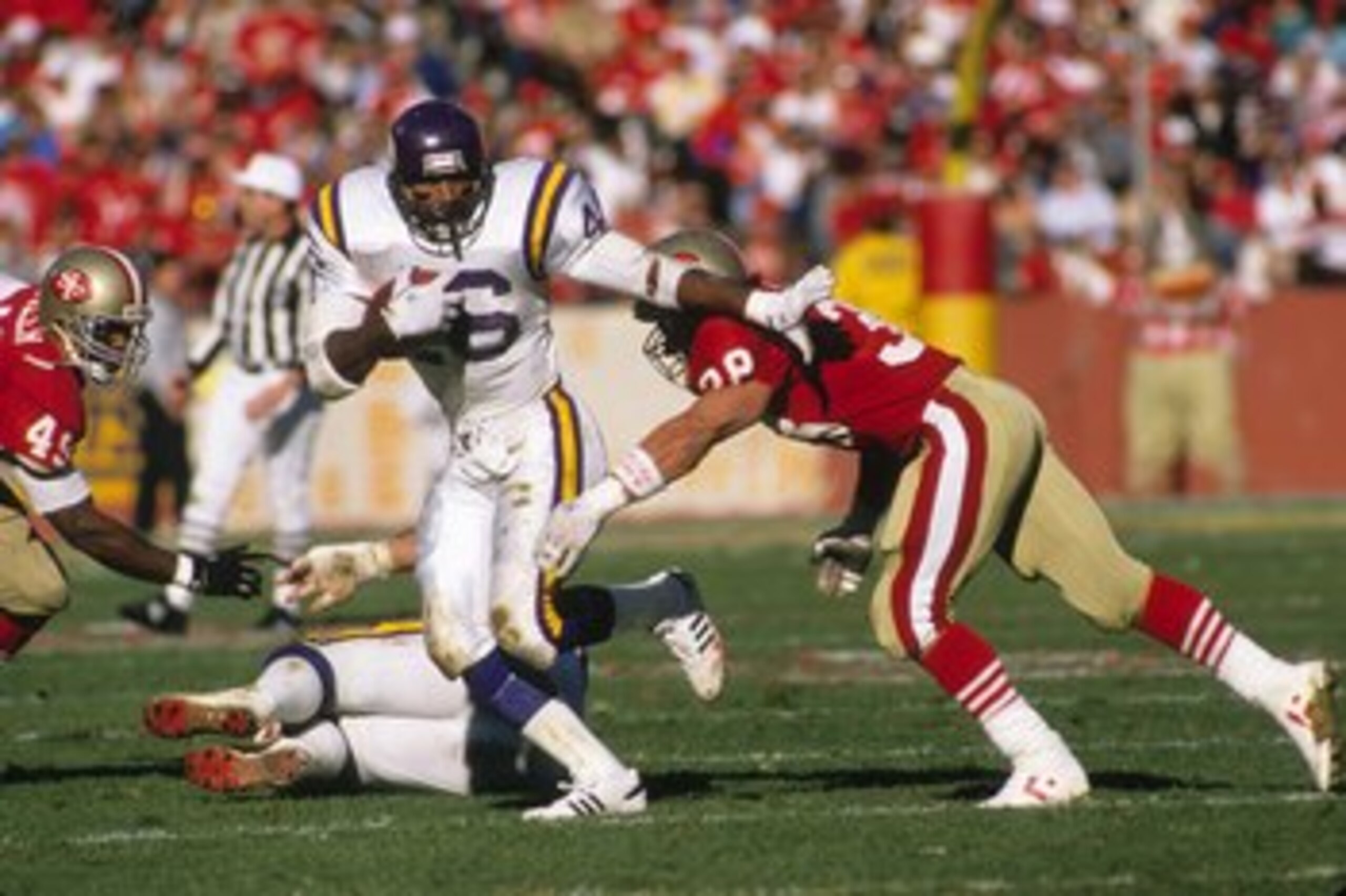 SAN FRANCISCO - JANUARY 1:  Running back Alfred Anderson #46 of the Minnesota Vikings looks for room to run against Jeff Fuller #49 and Greg Cox #38 of the San Francisco 49ers during the 1988 NFC Divisional Playoffs at Candlestick Park on January 1, 1989