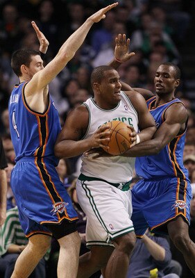 BOSTON - MARCH 31:  Glen Davis #11 of the Boston Celtics tries to break away from Nick Collison #4 and Serge Ibaka #9 of the Oklahoma City Thunder on March 31, 2010 at the TD Garden in Boston, Massachusetts. The Oklahoma City Thunder defeated the Boston C
