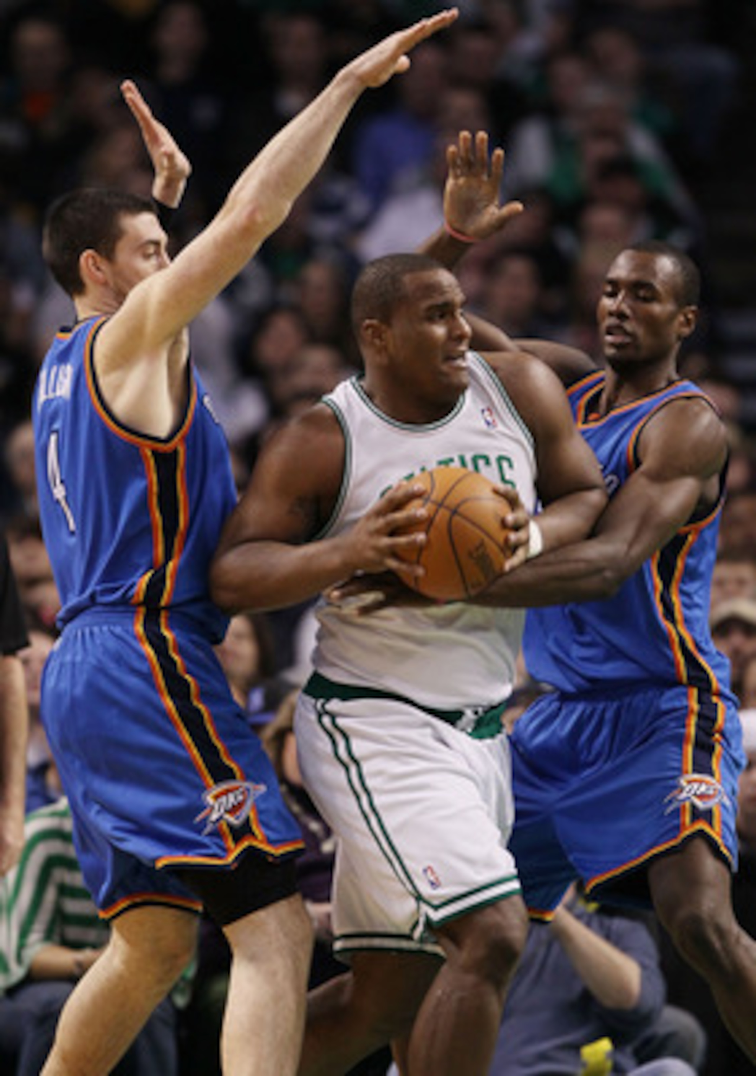 BOSTON - MARCH 31:  Glen Davis #11 of the Boston Celtics tries to break away from Nick Collison #4 and Serge Ibaka #9 of the Oklahoma City Thunder on March 31, 2010 at the TD Garden in Boston, Massachusetts. The Oklahoma City Thunder defeated the Boston C