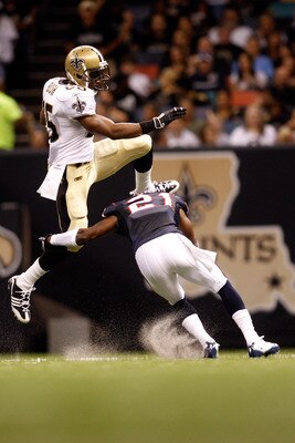 NEW ORLEANS - AUGUST 21:  Reggie Bush #25 of the New Orleans Saints jumps over Brice McCain #21 of the Houston Texans at the Louisiana Superdome on August 21, 2010 in New Orleans, Louisiana.  (Photo by Chris Graythen/Getty Images)