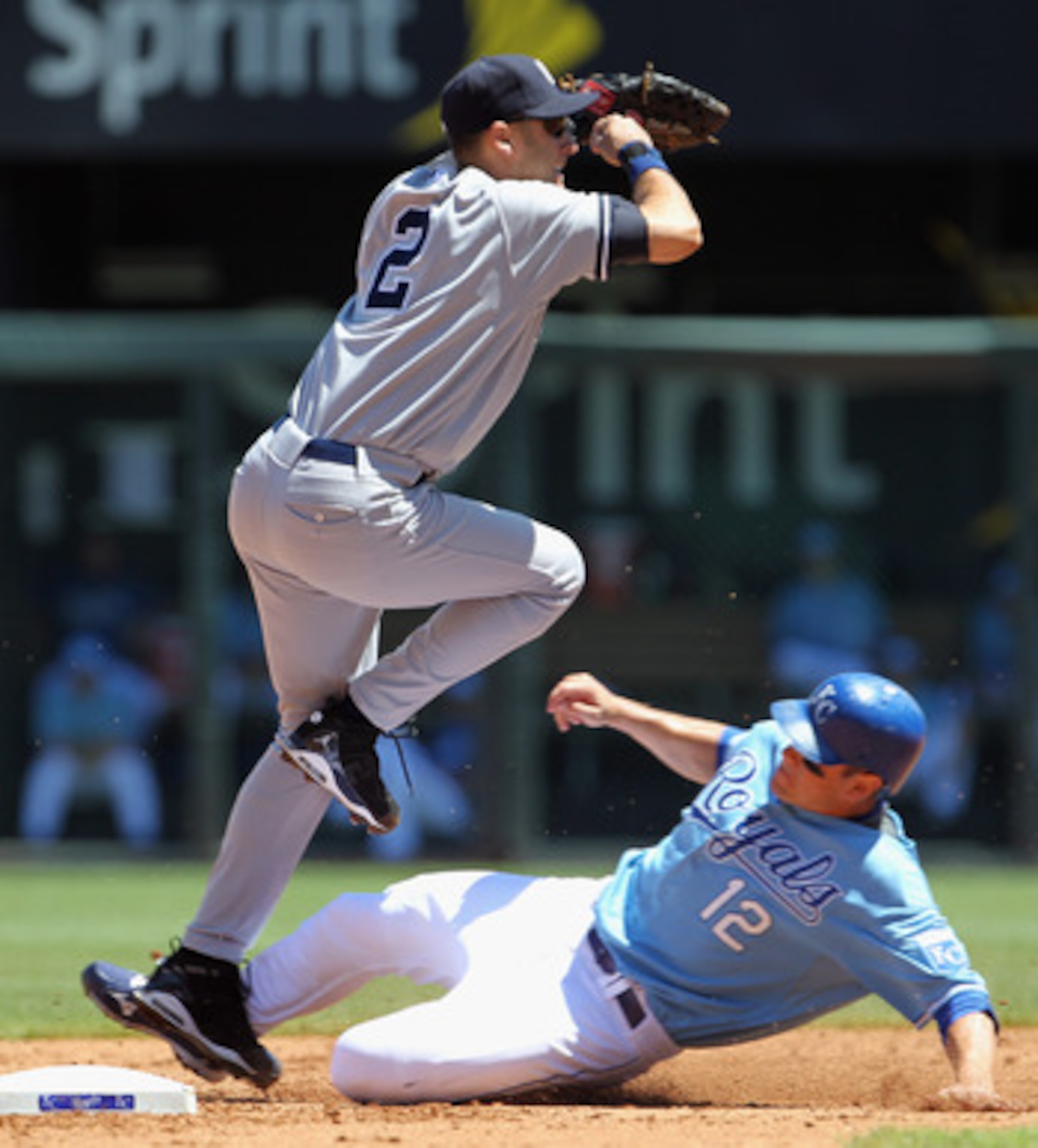 KANSAS CITY, MO - AUGUST 15:  Shortstop Derek Jeter #2 of the New York Yankees turns a double play as Mitch Maier #12 of the Kansas City Royals slides into second during the game on August 15, 2010 at Kauffman stadium in Kansas City, Missouri.  (Photo by