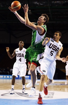 AUCKLAND, NEW ZEALAND - JULY 08:  Donatas Motiejunas of Lithuania takes the ball to the hoop as Seth Curry of the United States defends during the U19 Basketball World Championships match between the United States and Lithuania at North Shore Events Centr