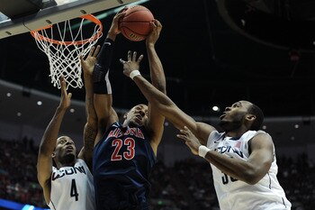 ANAHEIM, CA - MARCH 26:  Derrick Williams #23 of the Arizona Wildcats goes up for a rebound against Jamal Coombs-McDaniel #4 and Charles Okwandu #35 of the Connecticut Huskies during the west regional final of the 2011 NCAA men's basketball tournament at 