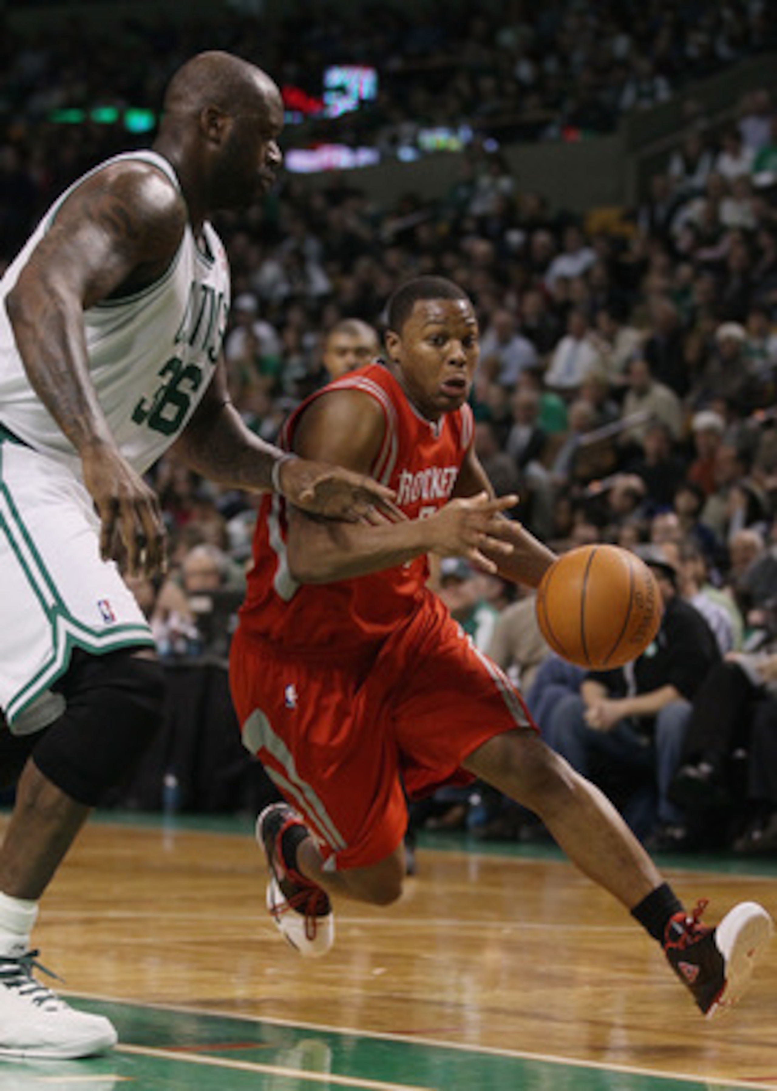 BOSTON, MA - JANUARY 10:  Kyle Lowry #7 of the Houston Rockets drives around Shaquille O'Neal #37 of the Boston Celtics on January 10, 2011 at the TD Garden in Boston, Massachusetts.  The Rockets defeated the Celtics 108-102. NOTE TO USER: User expressly 