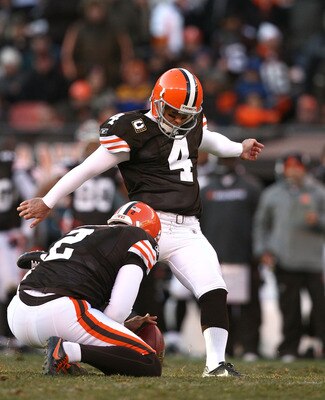 CLEVELAND - NOVEMBER 28:  Punter Reggie Hodges #2 holds as kicker Phil Dawson #4 of the Cleveland Browns kicks a fourth quarter field goal against the Carolina Panthers at Cleveland Browns Stadium on November 28, 2010 in Cleveland, Ohio.  (Photo by Matt S