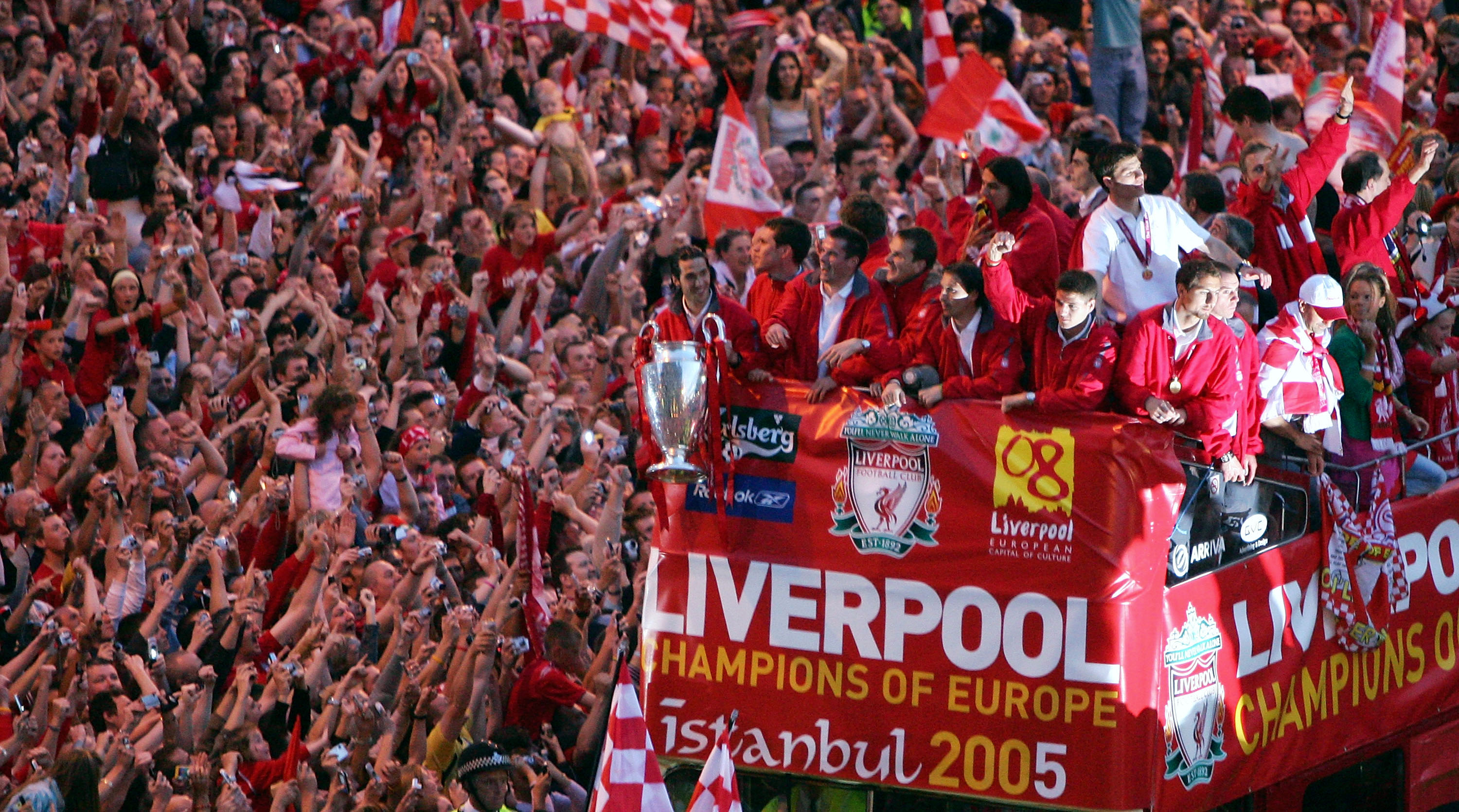 LIVERPOOL, ENGLAND - MAY 26:  The Liverpool team rides on an open top bus through a mass of fans as they arrive at St. George's Hall during the Liverpool Champions League Victory Parade on May 26, 2005 in Liverpool, England. Over 250,000 cheering fans hav