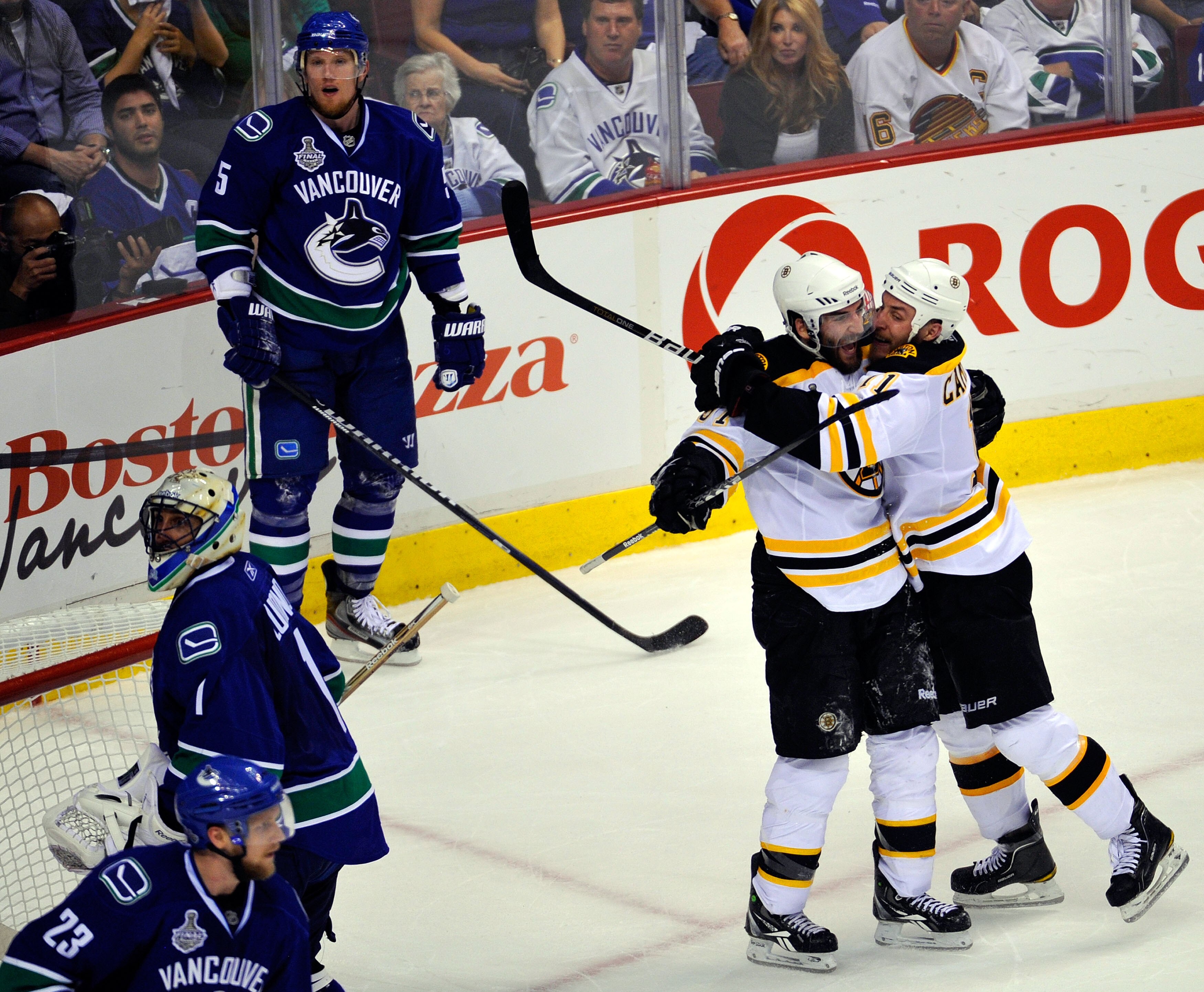 VANCOUVER, BC - JUNE 15: Patrice Bergeron #37 of the Boston Bruins celebrates with Gregory Campbell #11 after he scored the 3rd goal in the second period as Roberto Luongo #1, Christian Ehrhoff #5 and Alexander Edler #23 of the Vancouver Canucks look on VANCOUVER, BC - JUNE 15: Patrice Bergeron #37 of the Boston Bruins celebrates with Gregory Campbell #11 after he scored the 3rd goal in the second period as Roberto Luongo #1, Christian Ehrhoff #5 and Alexander Edler #23 of the Vancouver Canucks look on