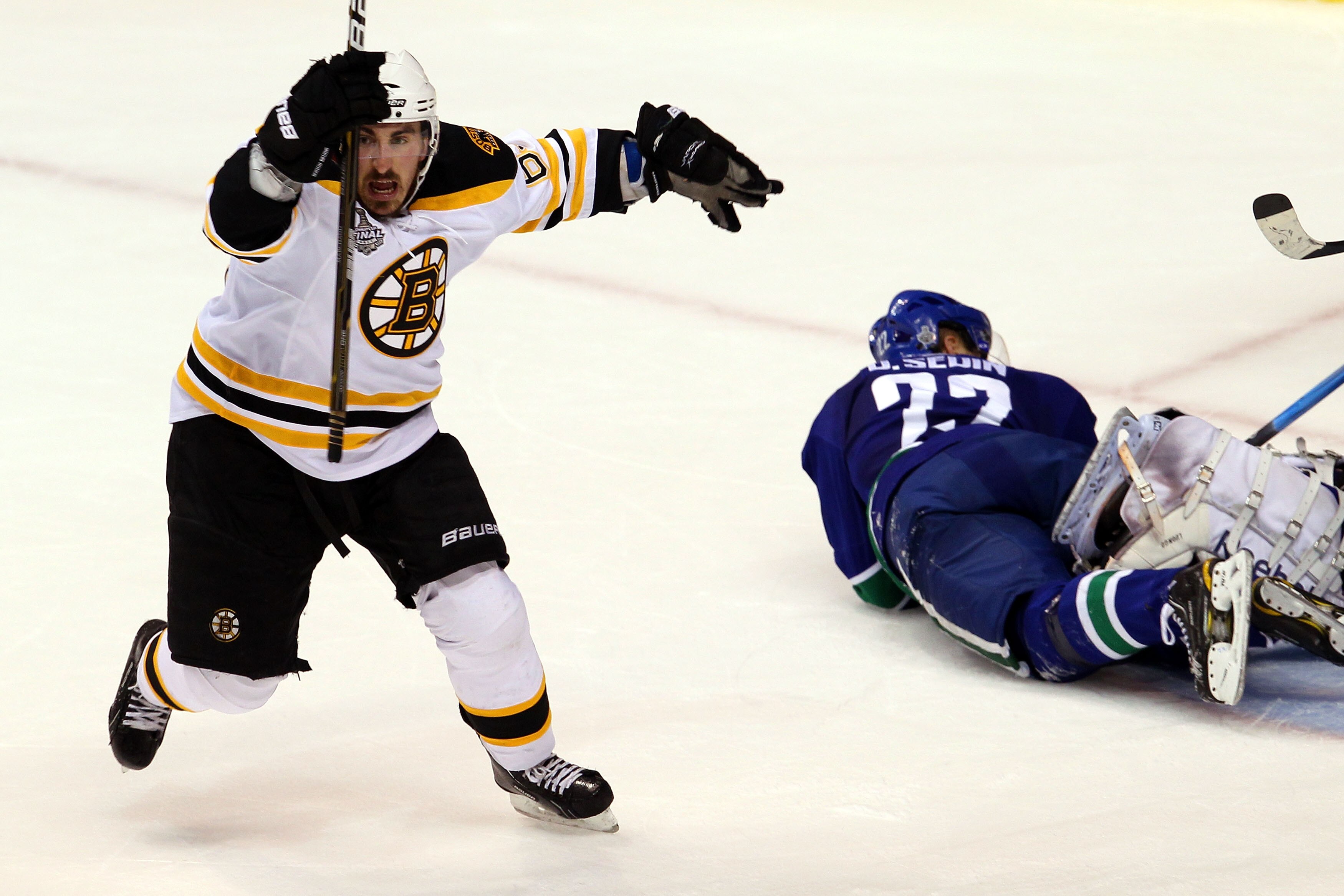 VANCOUVER, BC - JUNE 15: Brad Marchand #63 of the Boston Bruins celebrates after scoring a goal in the second period against Roberto Luongo #1 of the Vancouver Canucks as Daniel Sedin #22 lays on the ice during Game Seven of the 2011 NHL Stanley Cup Fina VANCOUVER, BC - JUNE 15: Brad Marchand #63 of the Boston Bruins celebrates after scoring a goal in the second period against Roberto Luongo #1 of the Vancouver Canucks as Daniel Sedin #22 lays on the ice during Game Seven of the 2011 NHL Stanley Cup Fina