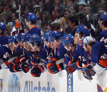 UNIONDALE, NY - APRIL 08:  The New York Islanders watch the shoot out against the Pittsburgh Penguins with their helmets on backwards for good luck at the Nassau Coliseum on April 8, 2011 in Uniondale, New York.  (Photo by Bruce Bennett/Getty Images)