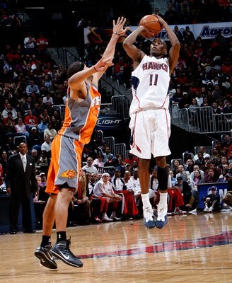ATLANTA - JANUARY 15:  Jamal Crawford #11 of the Atlanta Hawks against Jared Dudley #3 of the Phoenix Suns at Philips Arena on January 15, 2010 in Atlanta, Georgia.  NOTE TO USER: User expressly acknowledges and agrees that, by downloading and/or using th