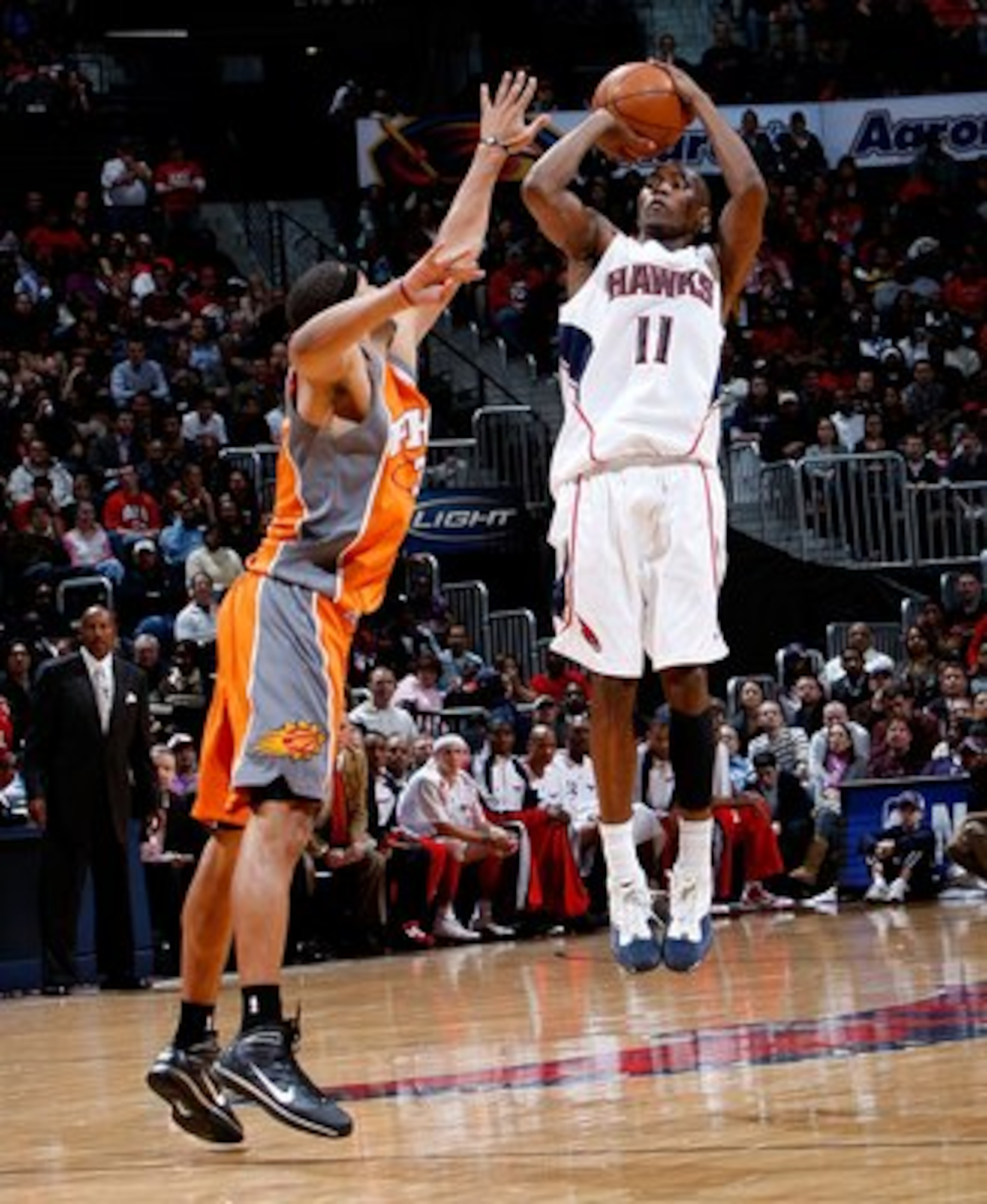 ATLANTA - JANUARY 15:  Jamal Crawford #11 of the Atlanta Hawks against Jared Dudley #3 of the Phoenix Suns at Philips Arena on January 15, 2010 in Atlanta, Georgia.  NOTE TO USER: User expressly acknowledges and agrees that, by downloading and/or using th
