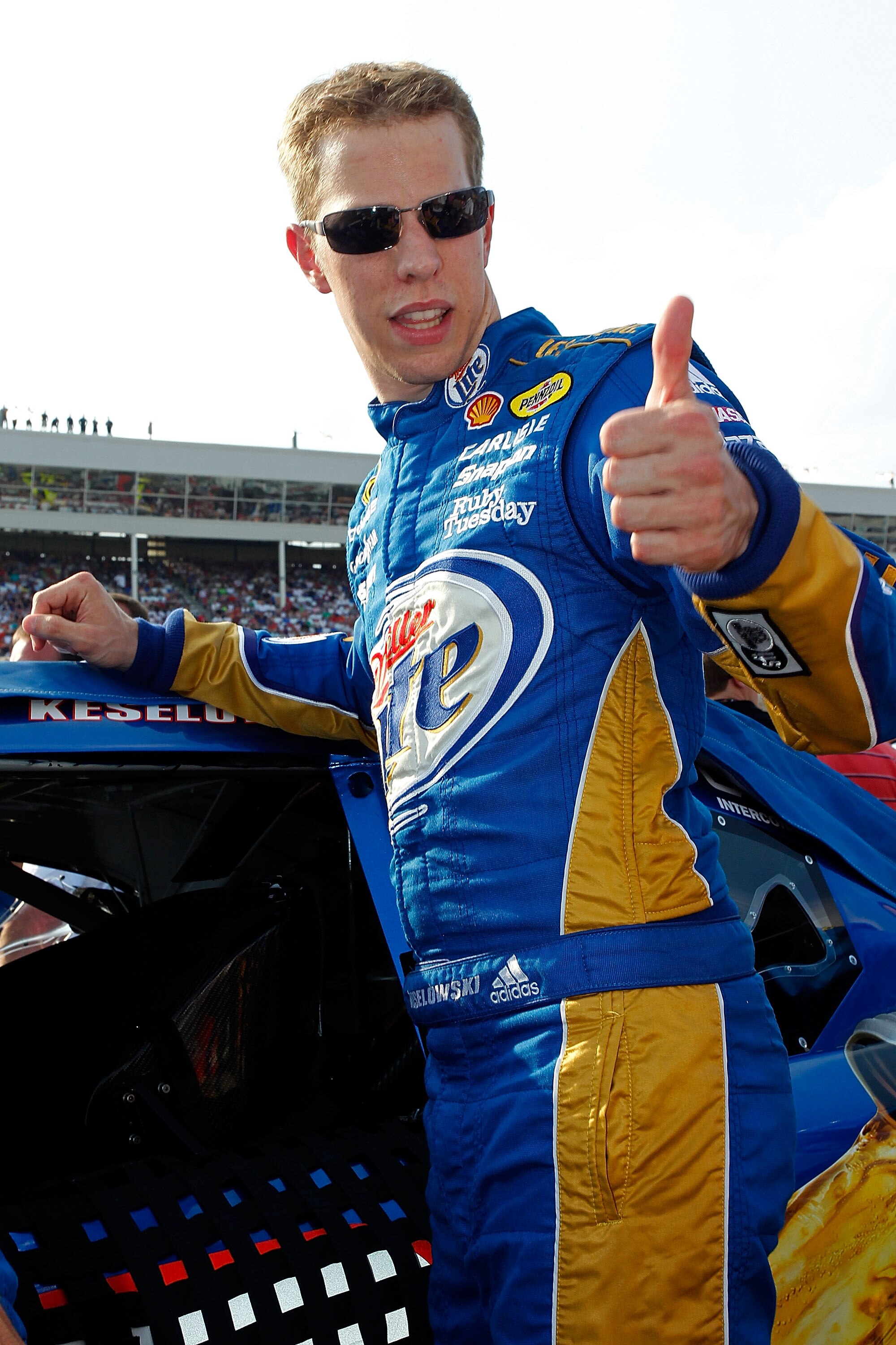 CONCORD, NC - MAY 29: Brad Keselowski, driver of the #2 Miller Lite Dodge, gives a thumbs up while standing by his car on the grid prior to the NASCAR Sprint Cup Series Coca-Cola 600 at Charlotte Motor Speedway on May 29, 2011 in Concord, North Carolina.
