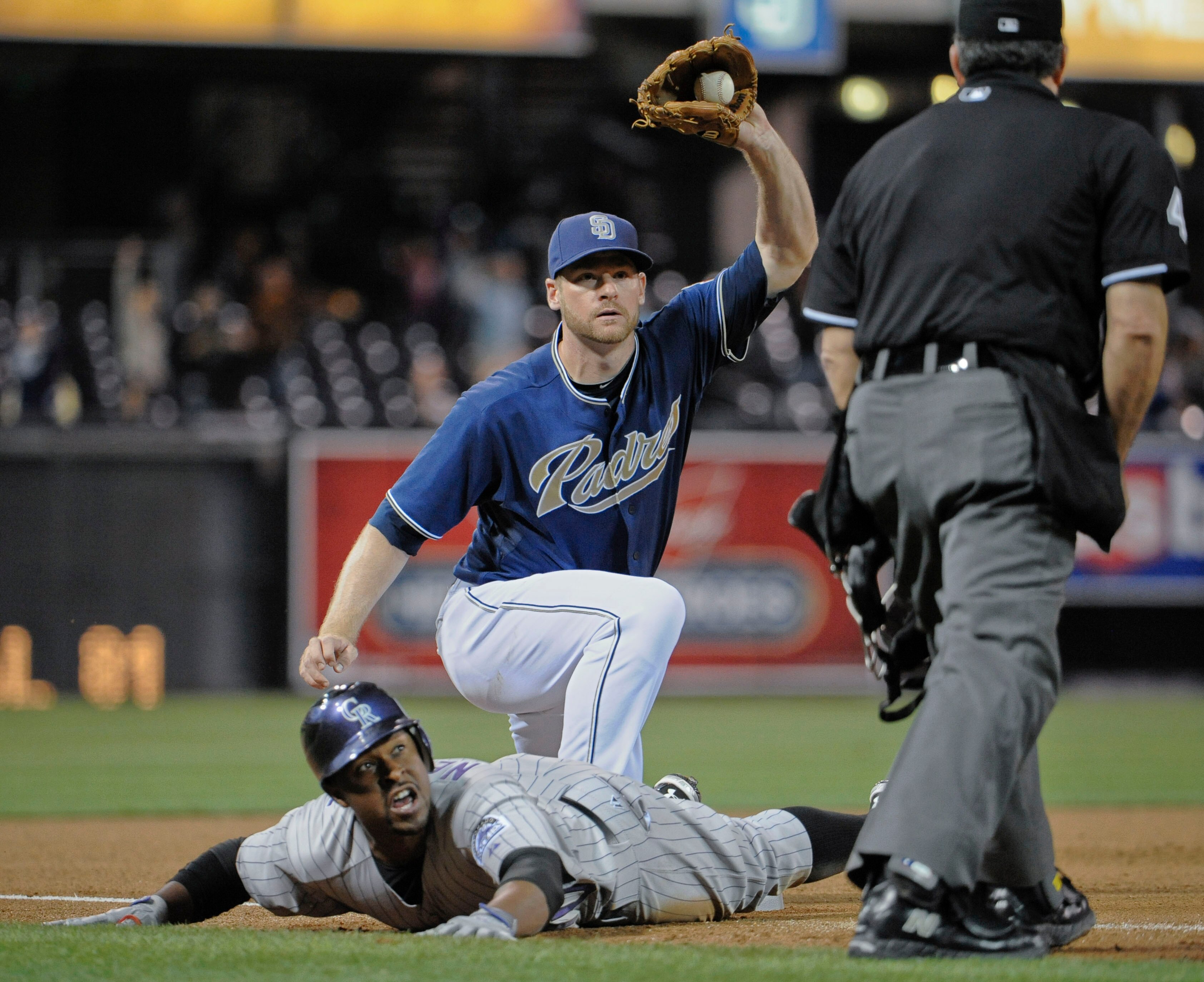 SAN DIEGO, CA - JUNE 6: Chris Nelson #10 of the Colorado Rockies is tagged out at third base by Chase Headley #7 of the San Diego Padres during the sixth inning of a baseball game at Petco Park on June 6, 2011 in San Diego, California. Nelson tried to str