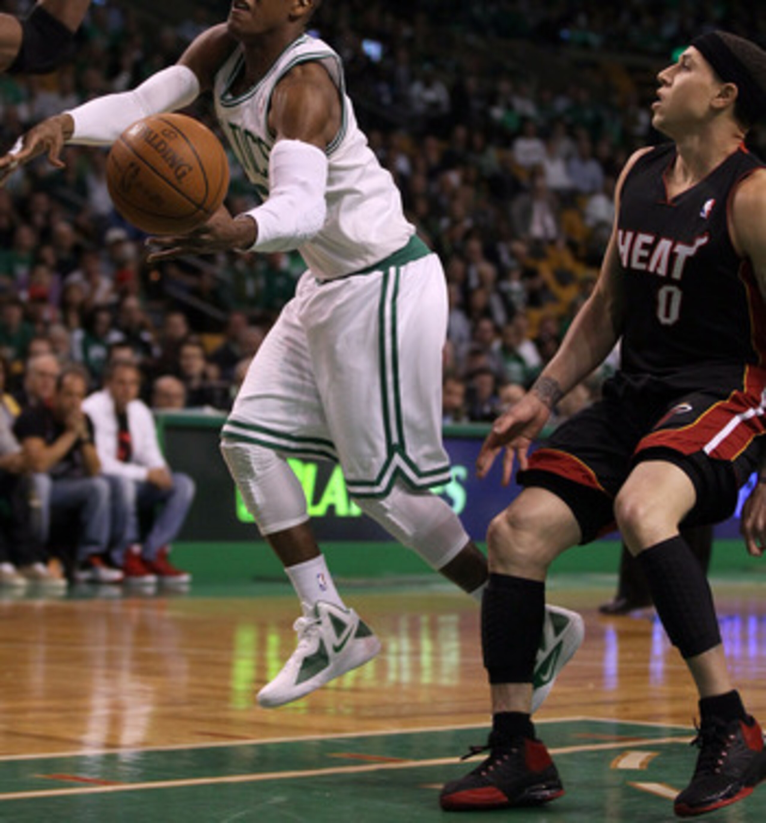 BOSTON, MA - MAY 09: Rajon Rondo #9 of the Boston Celtics is tripped by Mike Bibby #0 of the Miami Heat in Game Four of the Eastern Conference Semifinals in the 2011 NBA Playoffs on May 9, 2011 at the TD Garden in Boston, Massachusetts.  NOTE TO USER: Use