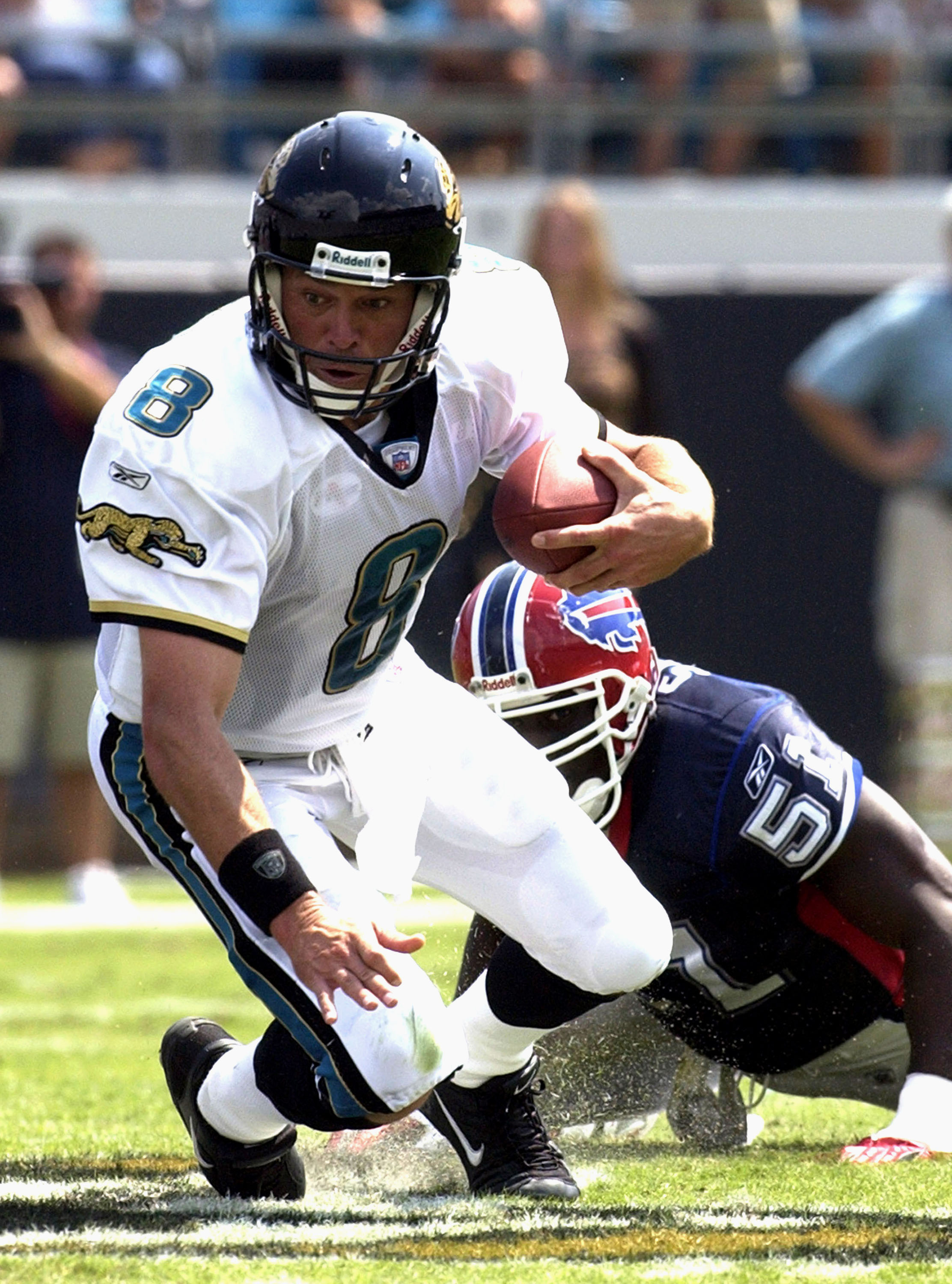 Jacksonville Jaguars quarterback Mark Brunell scrambles against the Buffalo Bills pass rush  Sunday, September 14, 2003 at Alltel Stadium, Jacksonville.  The Bills defeated the Jaguars 38 - 17.  (Photo by Al Messerschmidt/Getty Images)