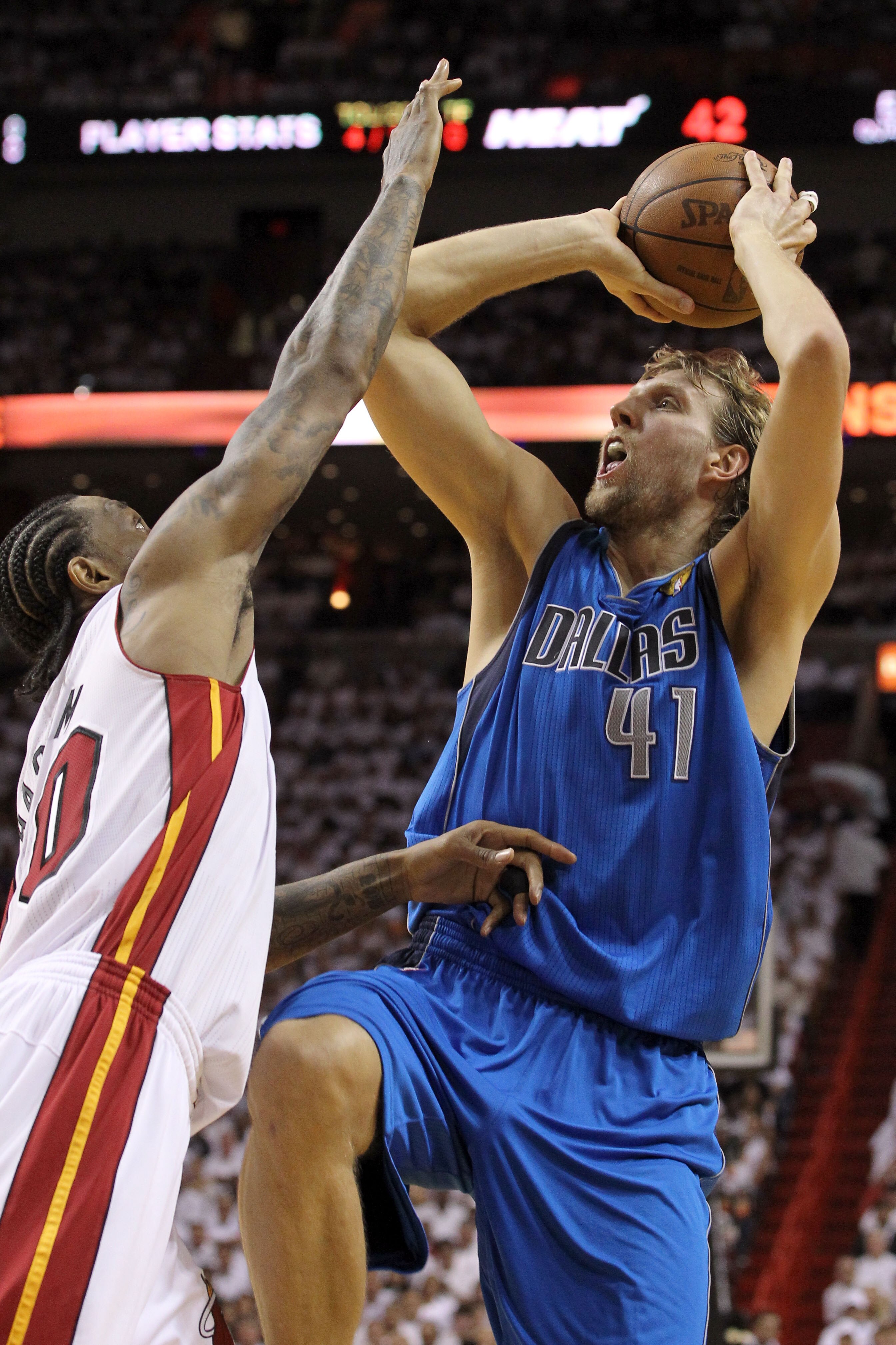 MIAMI, FL - JUNE 12:  Dirk Nowitzki #41 of the Dallas Mavericks attempts a shot against Udonis Haslem #40 of the Miami Heat in Game Six of the 2011 NBA Finals at American Airlines Arena on June 12, 2011 in Miami, Florida. NOTE TO USER: User expressly ackn