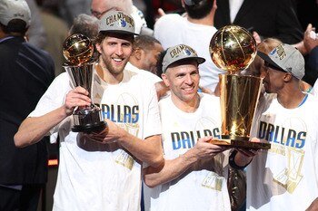 MIAMI, FL - JUNE 12:  (L-R) Finals MVP Dirk Nowitzki #41, Jason Kidd #2 and Jason Terry #31 of the Dallas Mavericks celebrate with the Larry O'Brien trophy after they won 105-95 against the Miami Heat in Game Six of the 2011 NBA Finals at American Airline