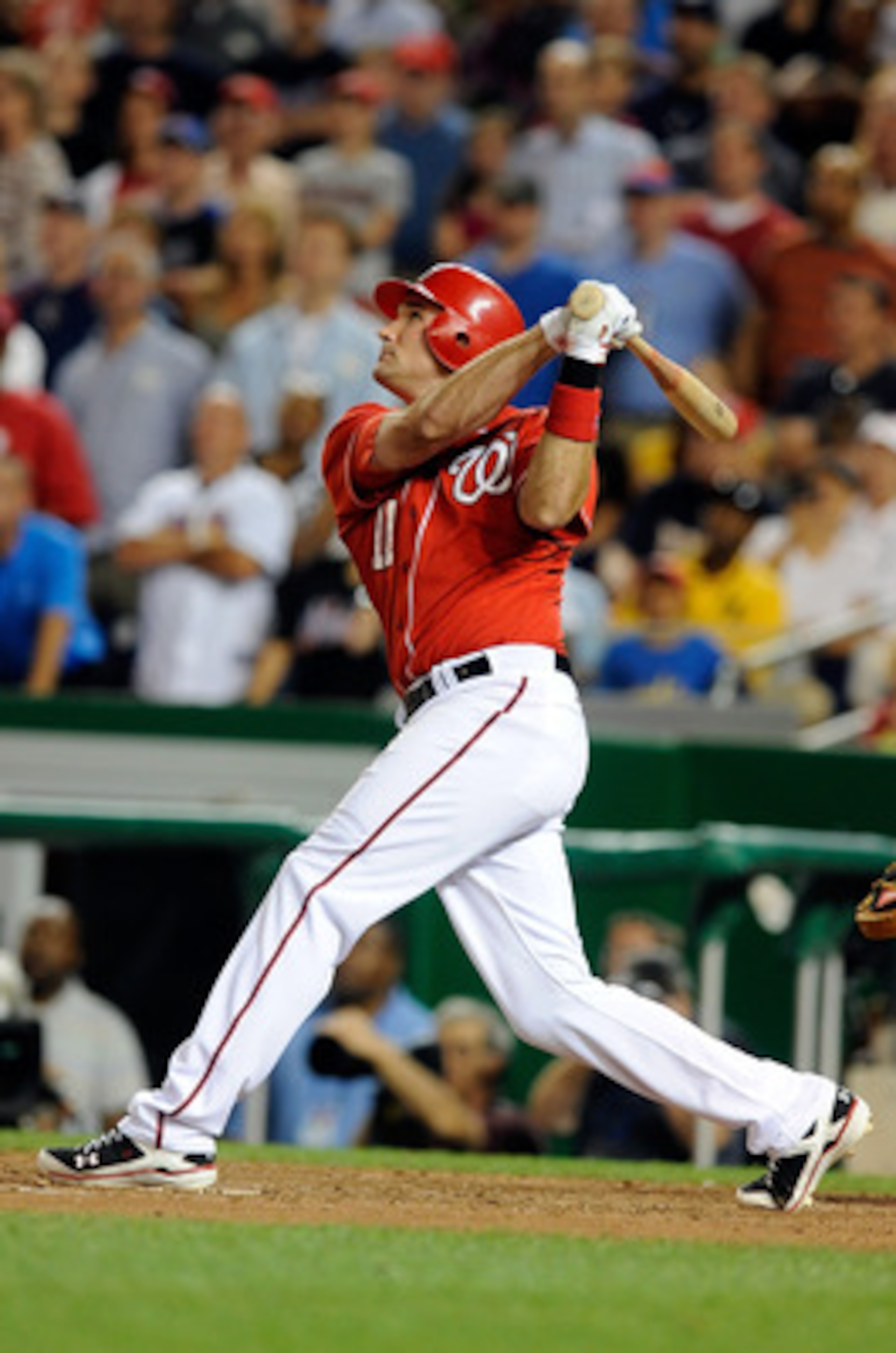 WASHINGTON - JULY 01:  Ryan Zimmerman #11 of the Washington Nationals hits a sacrifice fly to drive in the winning run in the ninth inning against the New York Mets at Nationals Park on July 1, 2010 in Washington, DC. The Nationals won the game 2-1.  (Pho