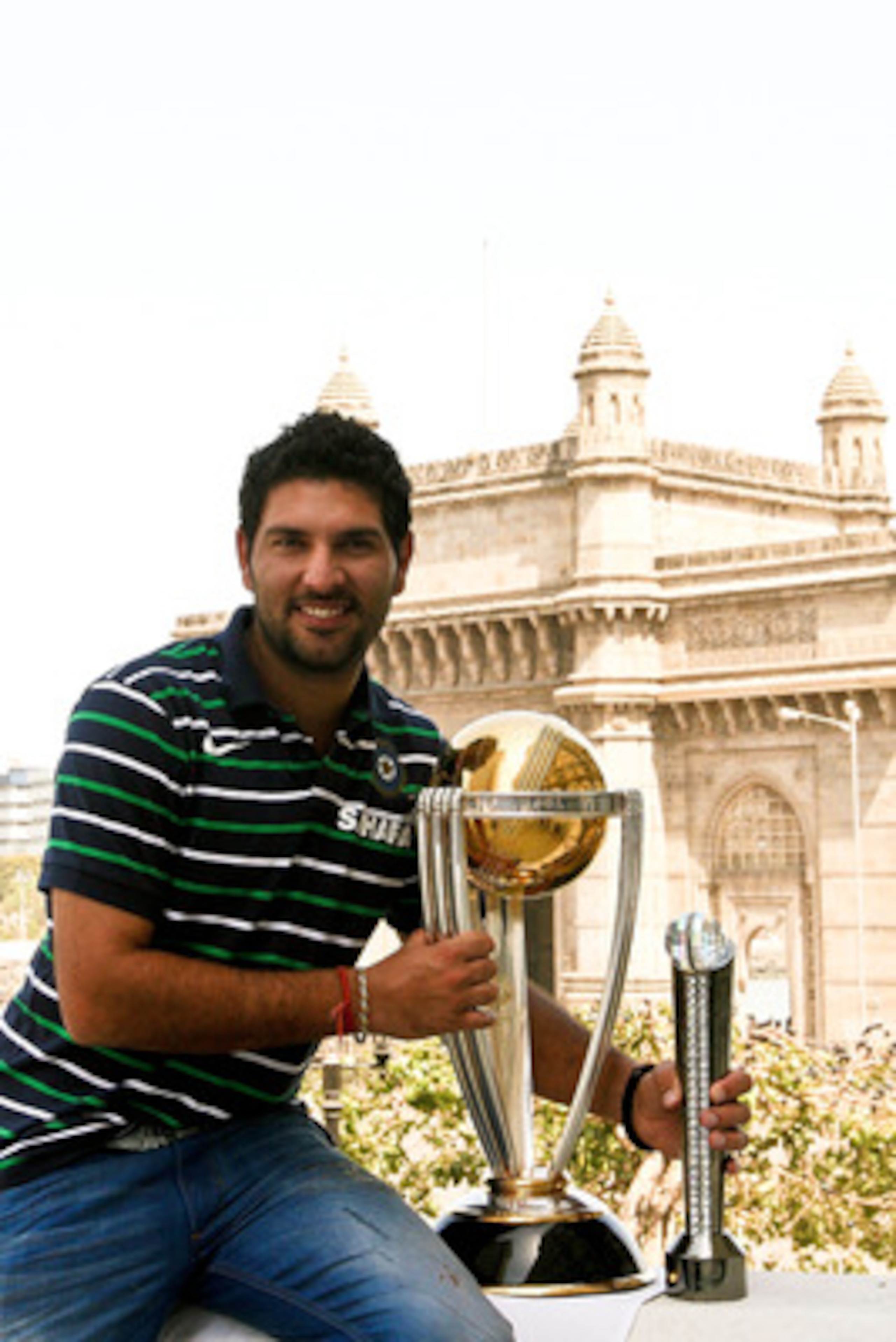 MUMBAI, INDIA - APRIL 03:  Yuvraj Singh of the Indian cricket team poses with the  ICC Cricket World Cup Trophy, with the Gateway of India in the backdrop, during a photo call at the Taj Palace Hotel on April 3, 2011 in Mumbai, India.  (Photo by Ritam Ban