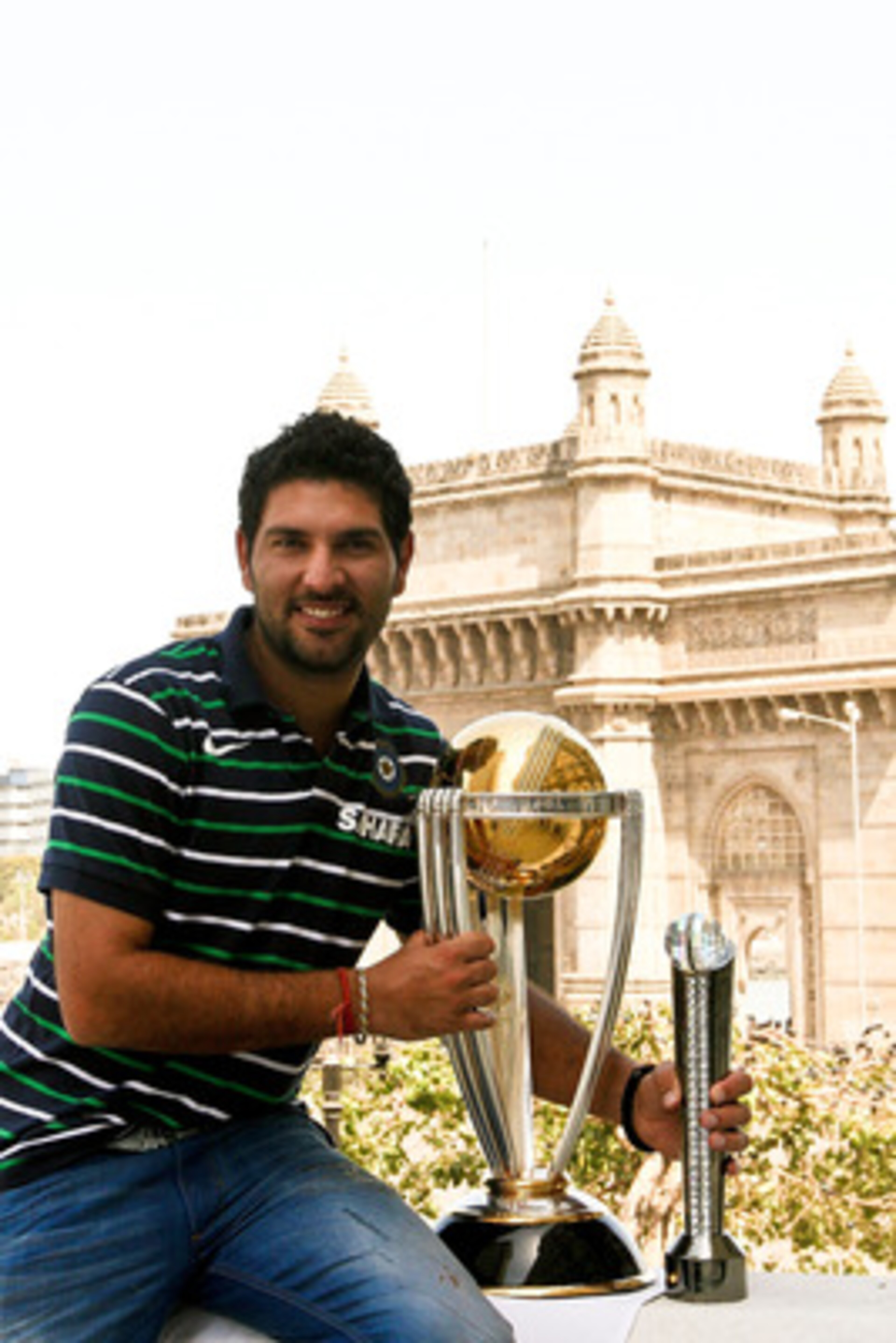 MUMBAI, INDIA - APRIL 03:  Yuvraj Singh of the Indian cricket team poses with the  ICC Cricket World Cup Trophy, with the Gateway of India in the backdrop, during a photo call at the Taj Palace Hotel on April 3, 2011 in Mumbai, India.  (Photo by Ritam Ban