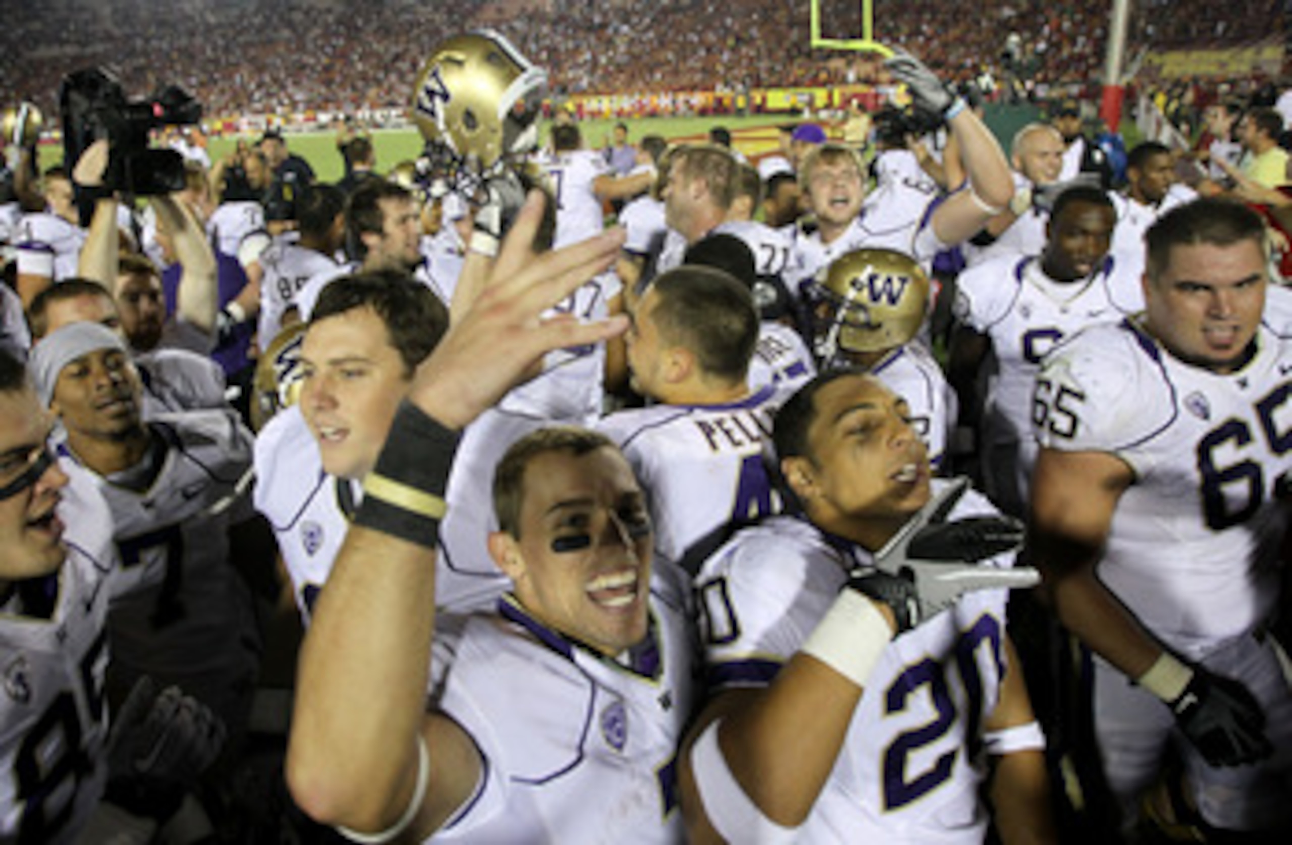 LOS ANGELES, CA - OCTOBER 02:  The Washington Huskies celebrate after the game with the USC Trojans at the Los Angeles Memorial Coliseum on October 2, 2010 in Los Angeles, California.  Washington won 32-31.  (Photo by Stephen Dunn/Getty Images)